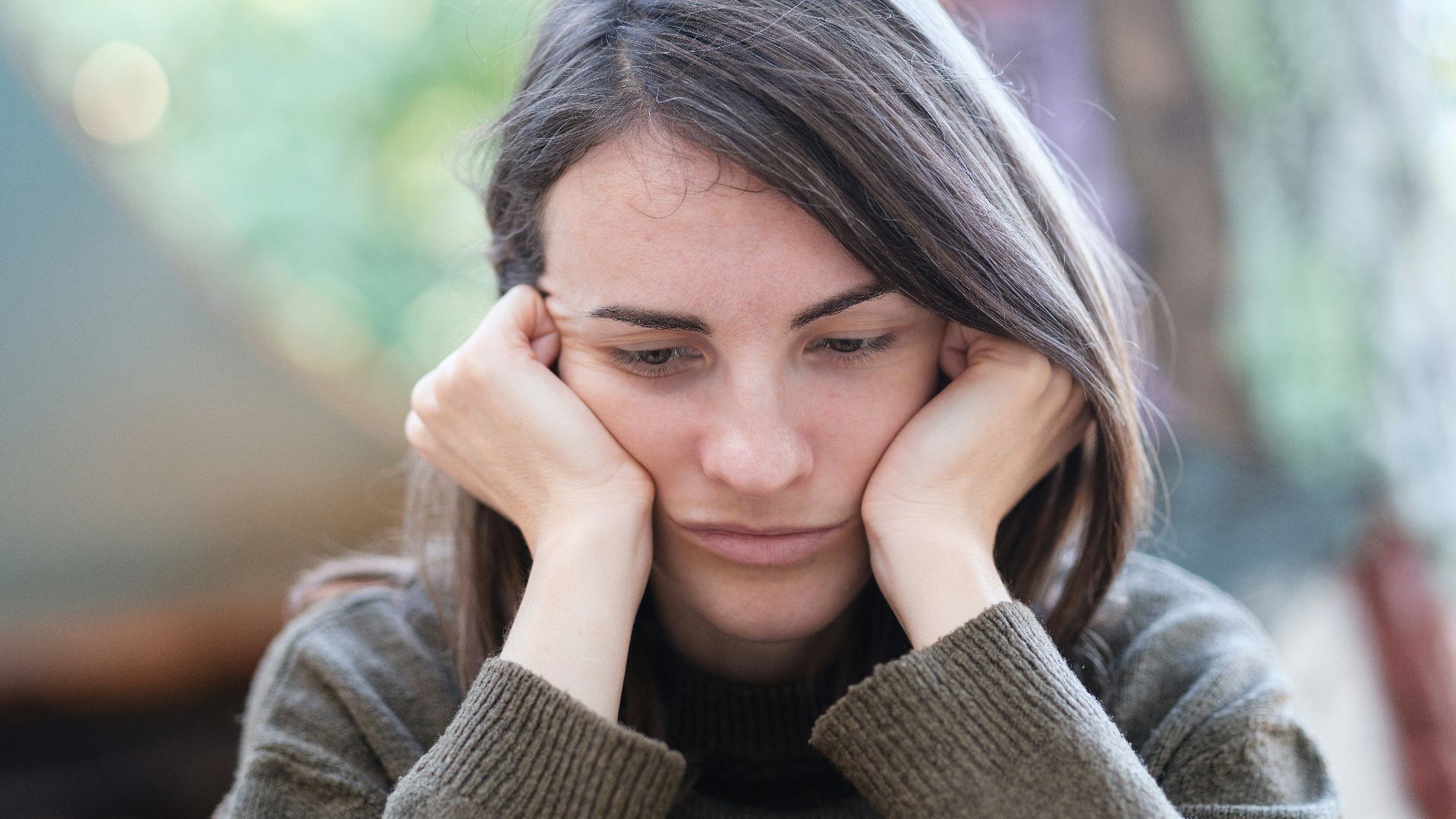 a woman holding her head in her hands