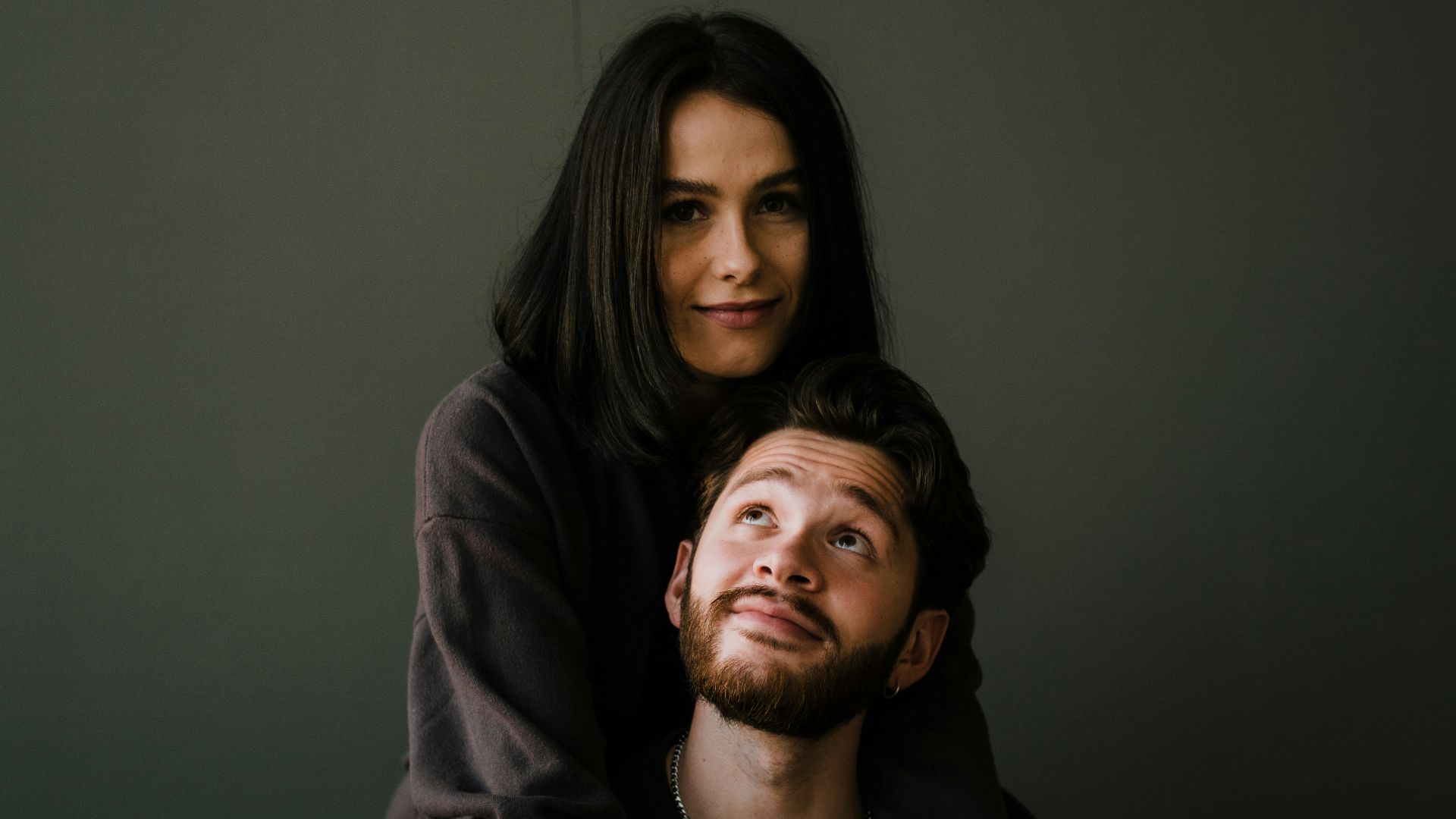 man in black crew neck shirt beside woman in black long sleeve shirt