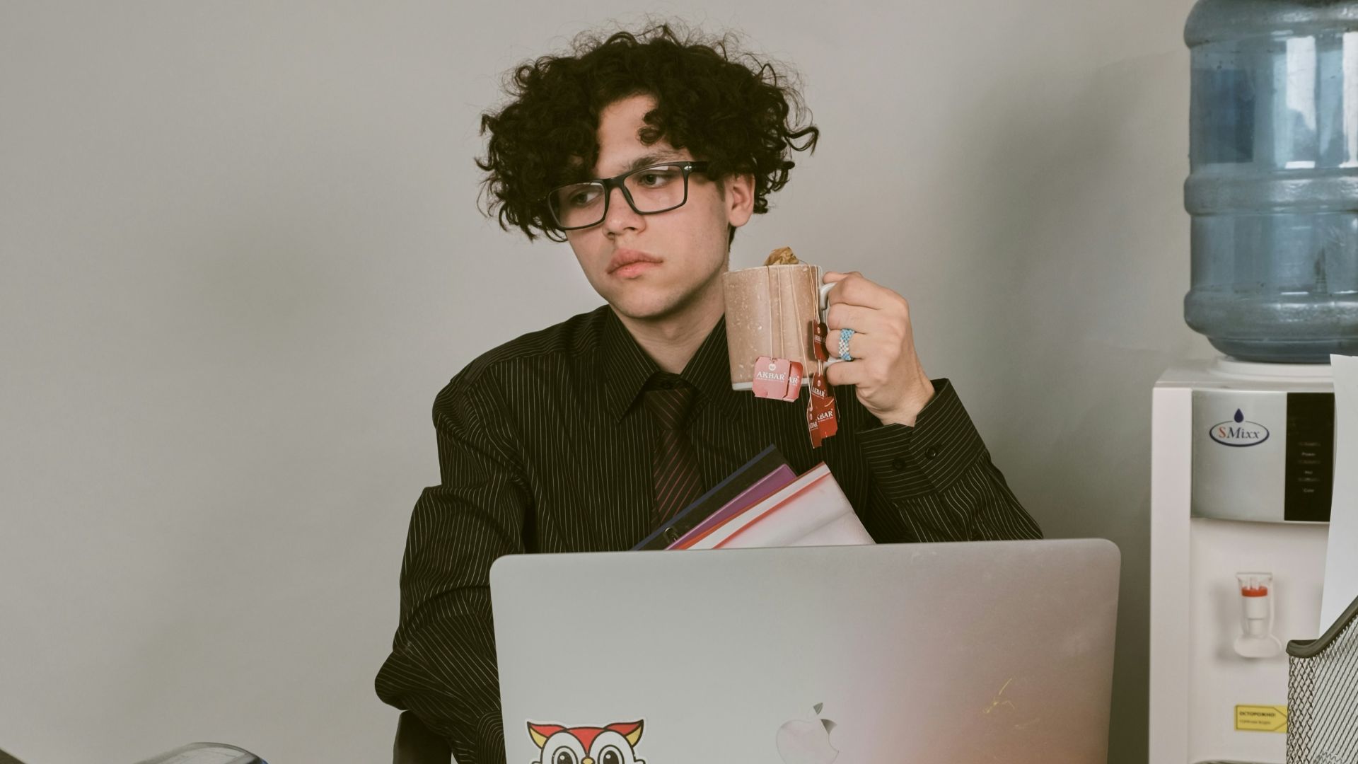 a man sitting at a desk with a laptop