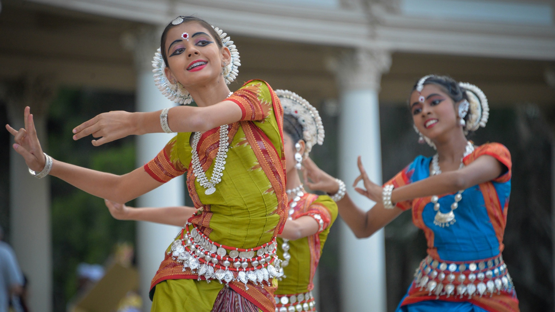 three woman performing traditional dance