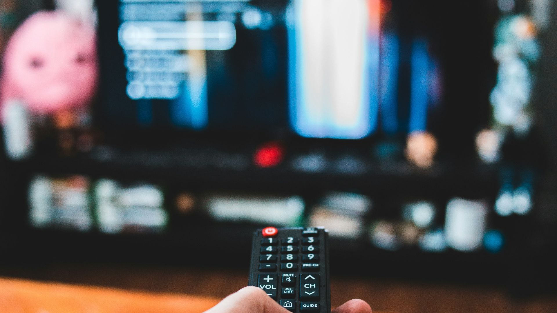 person holding black remote control