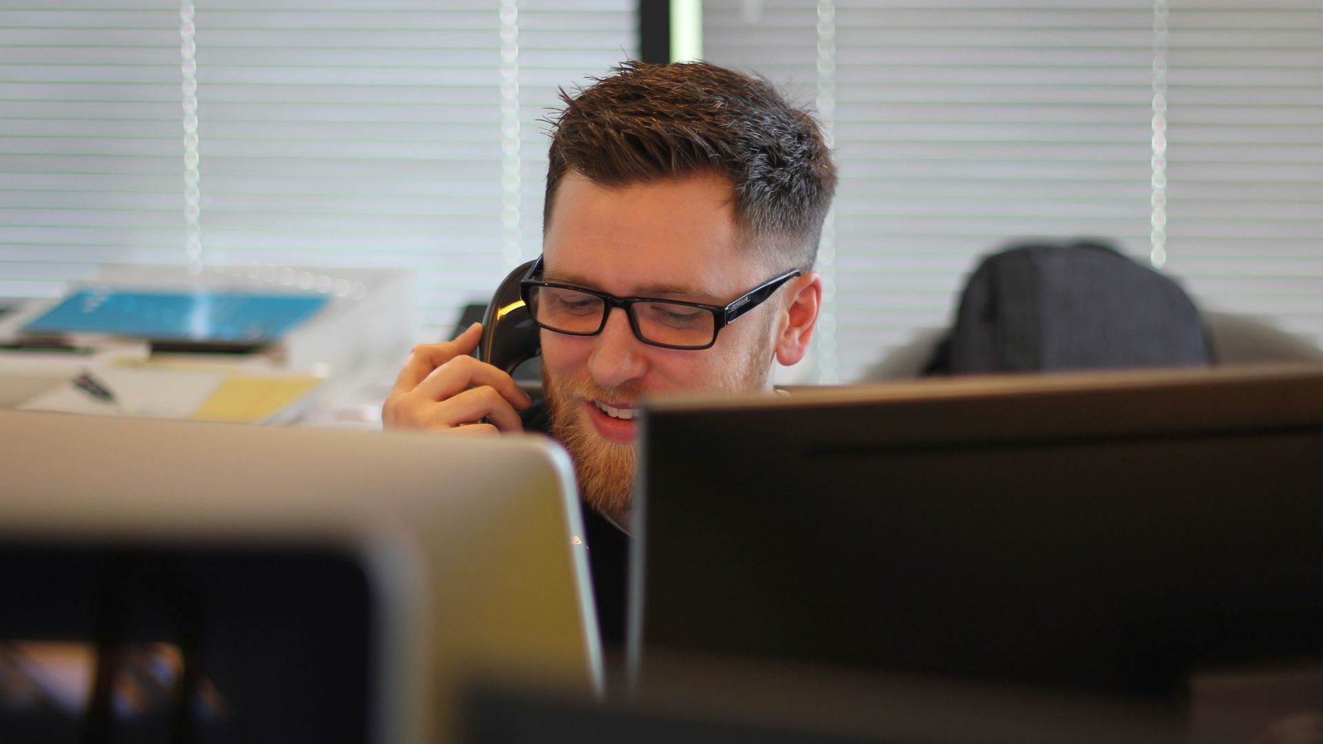 man using IP phone inside room