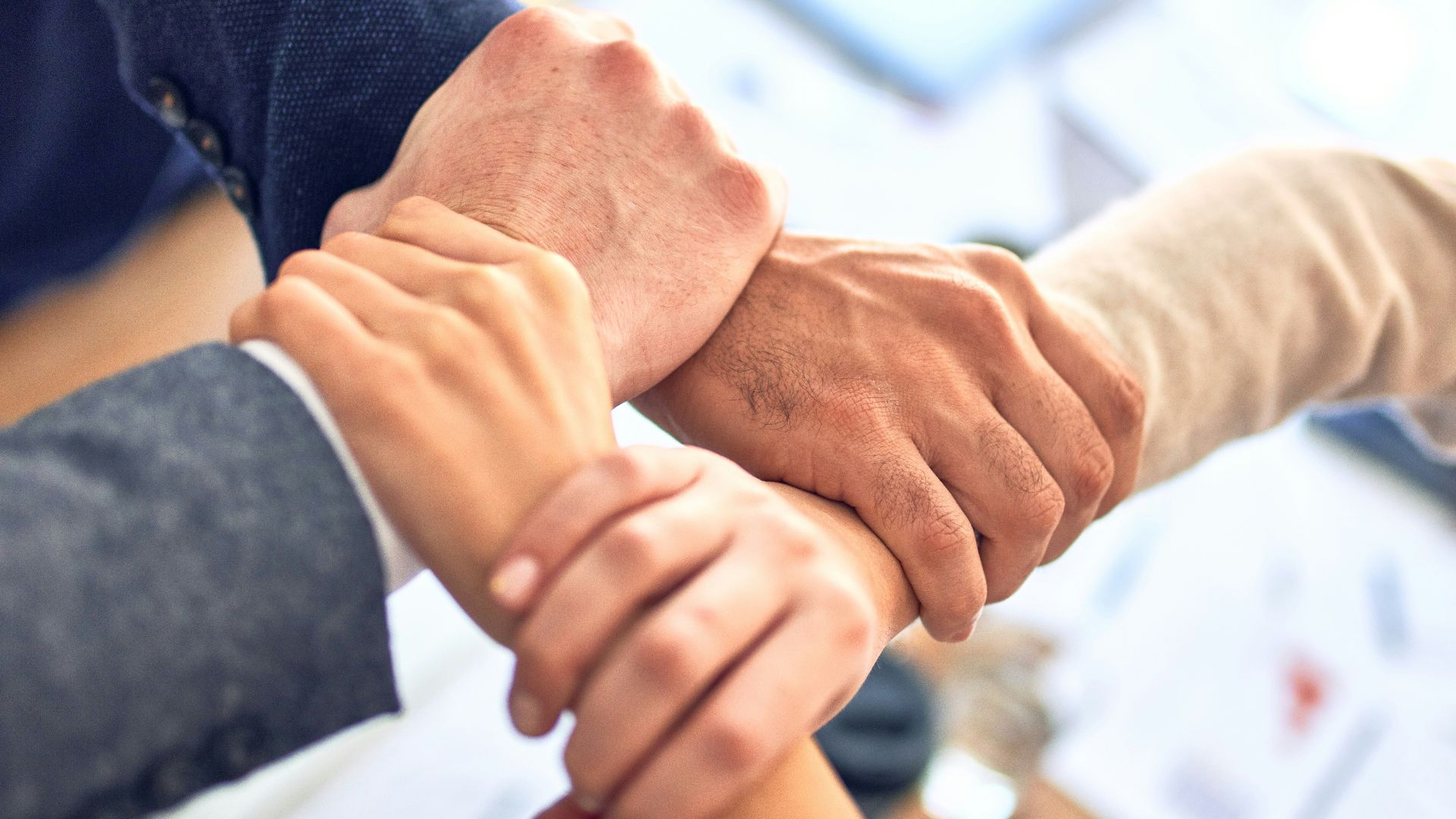 person in black long sleeve shirt holding persons hand