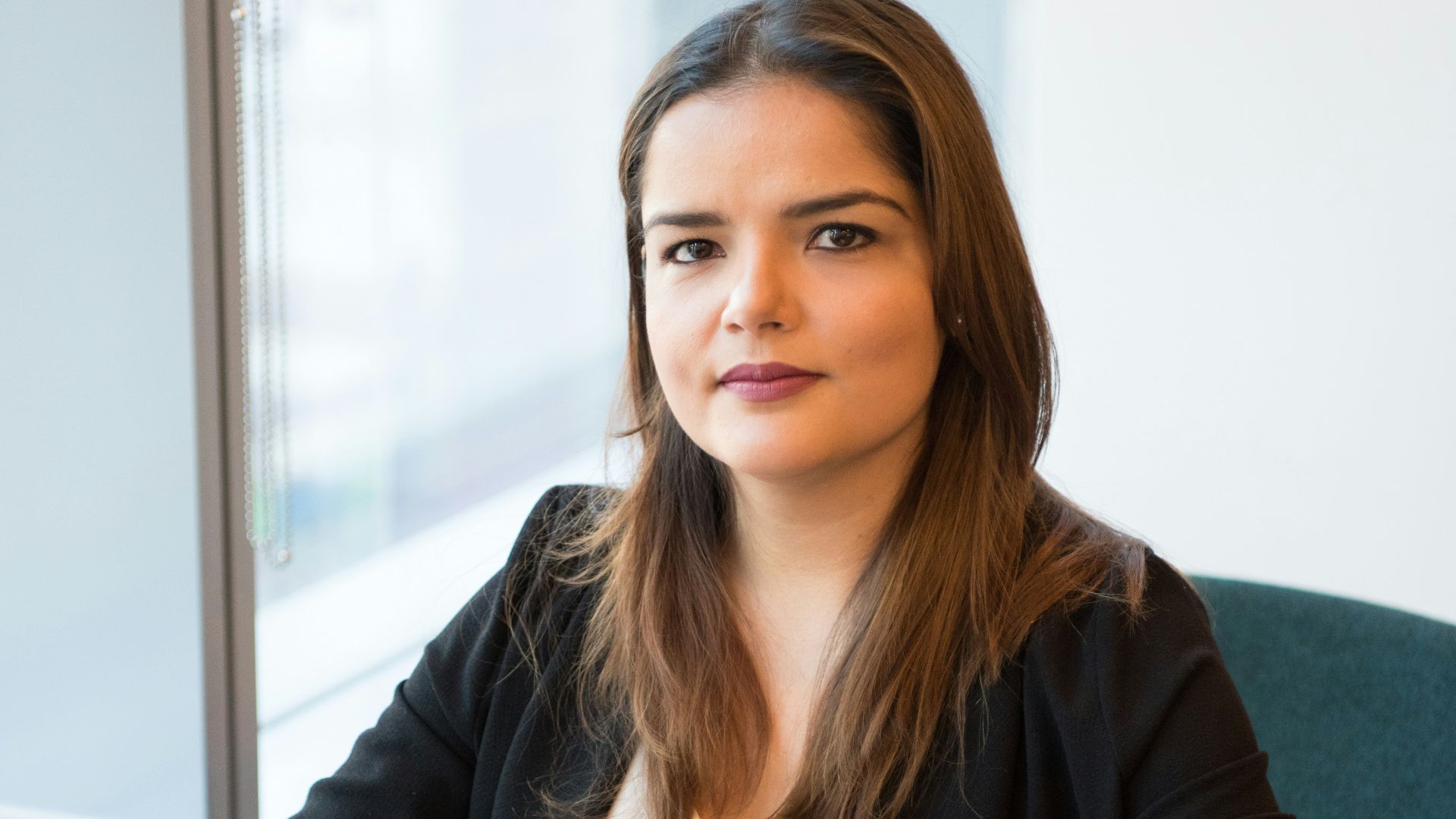 woman in black blazer using MacBook