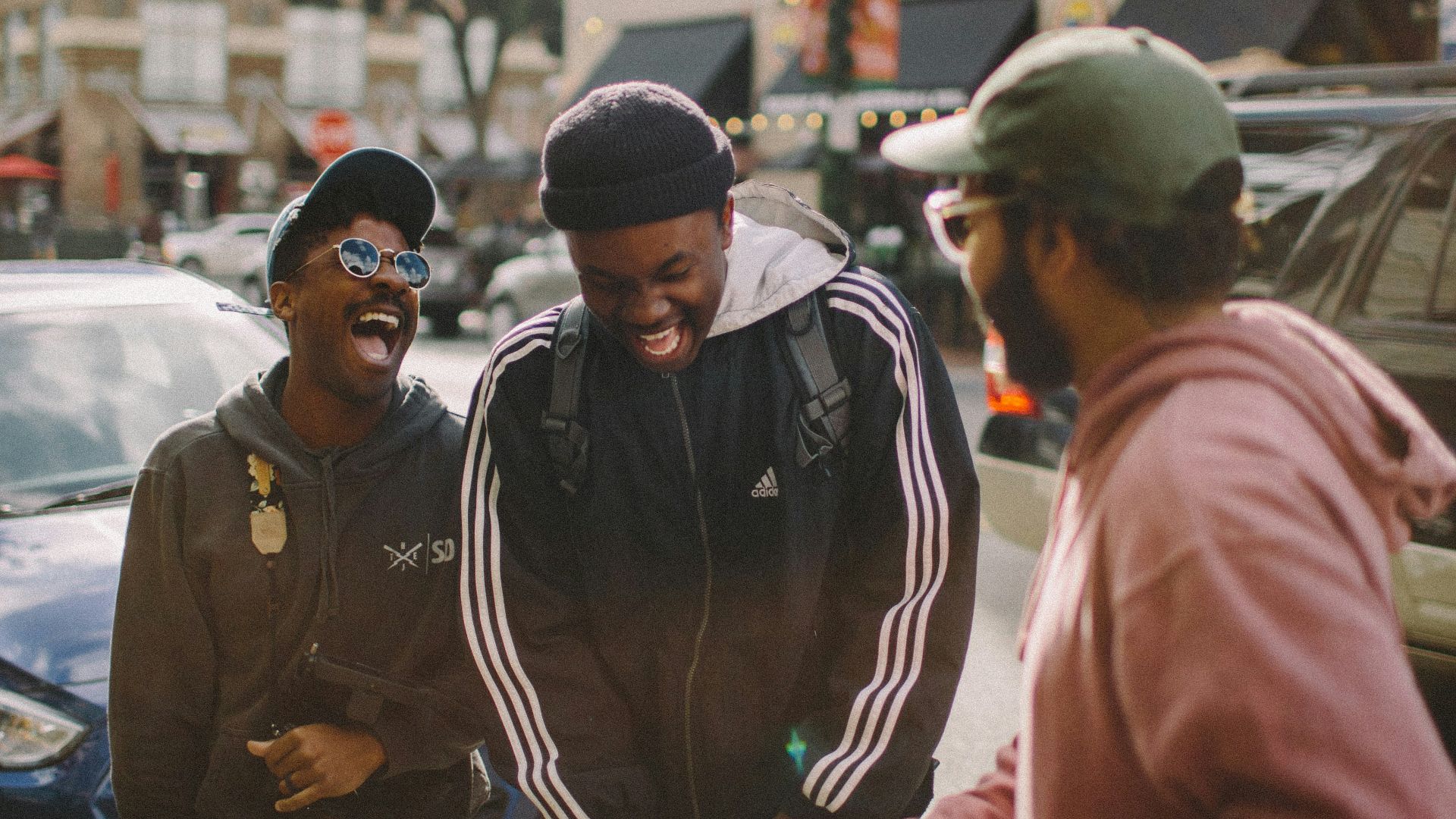 three men in jacket laughing at each other
