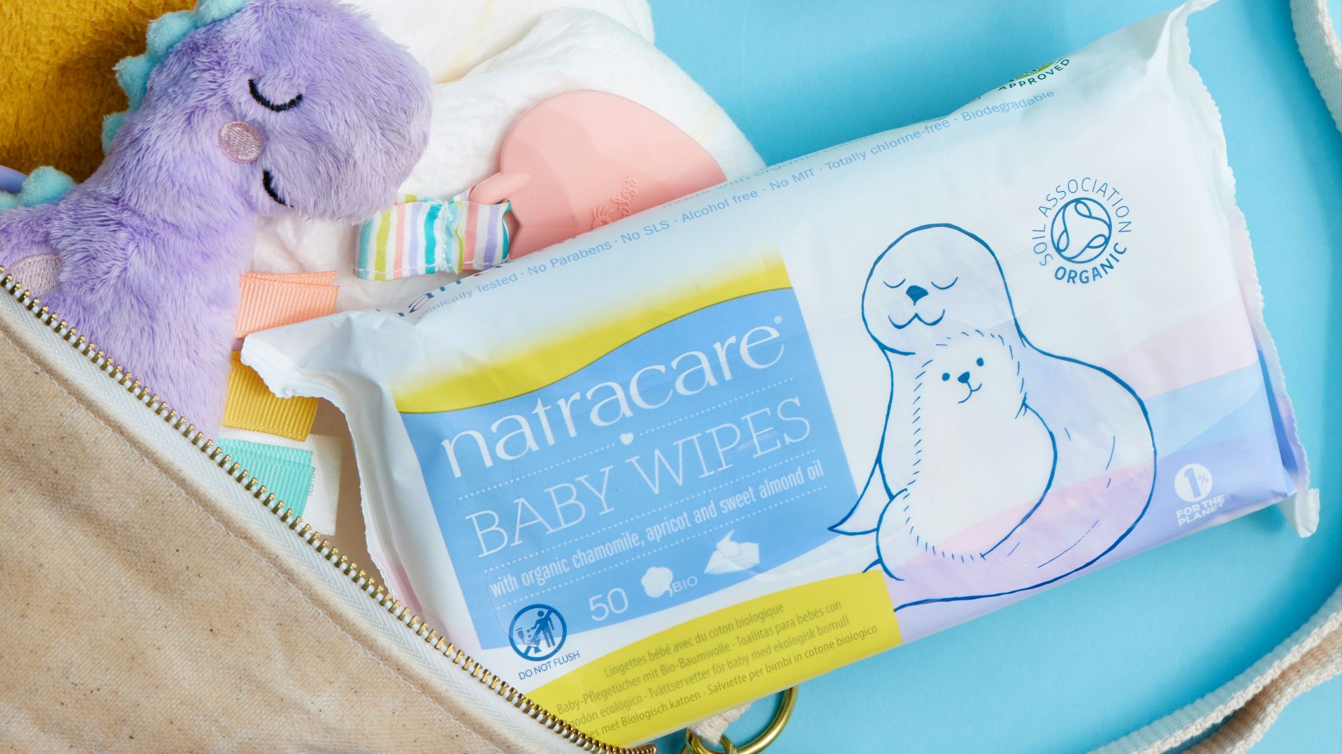 A diaper bag filled with baby items and a stuffed animal