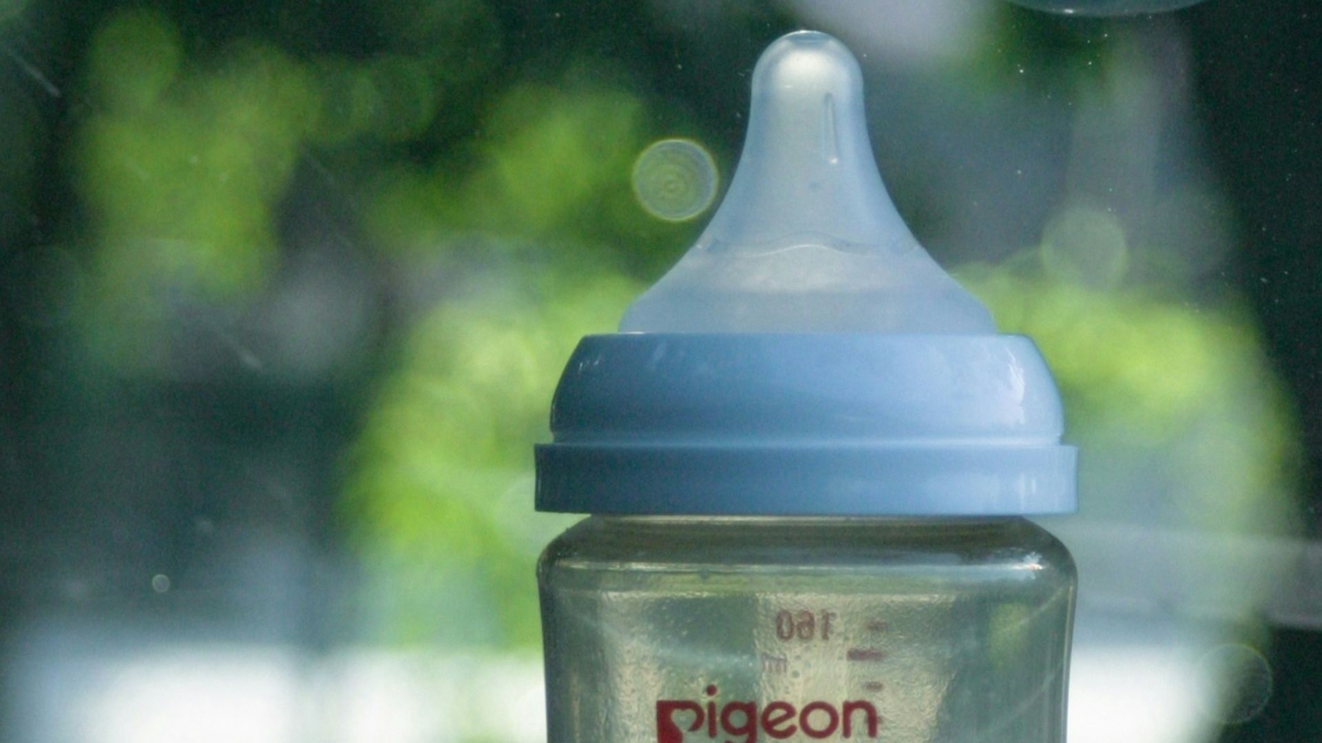 A baby bottle sits inside a car.