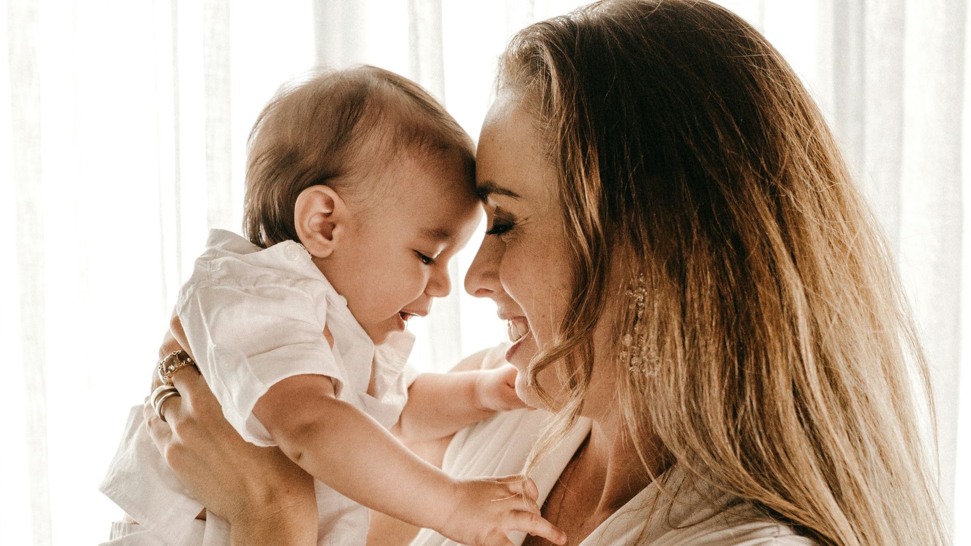 smiling woman carrying baby