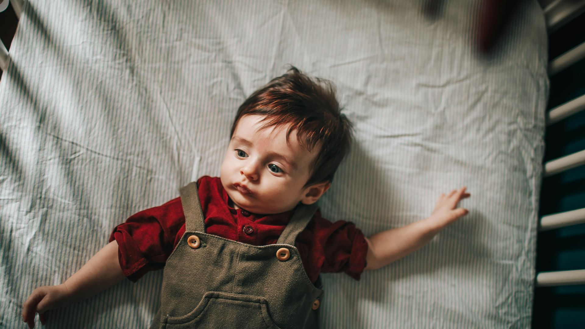 girl in red button up shirt lying on bed