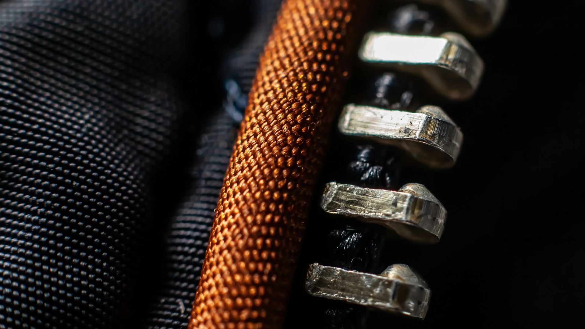 a close up of a black and orange zippered zipper
