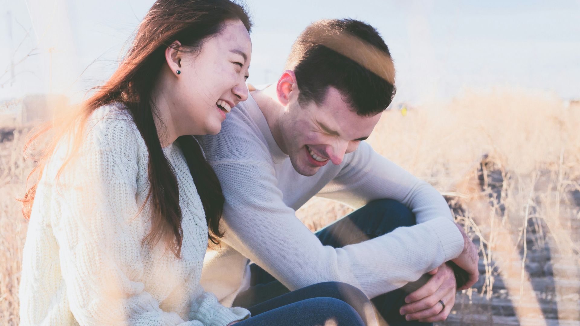 photo of man and woman laughing during daytime