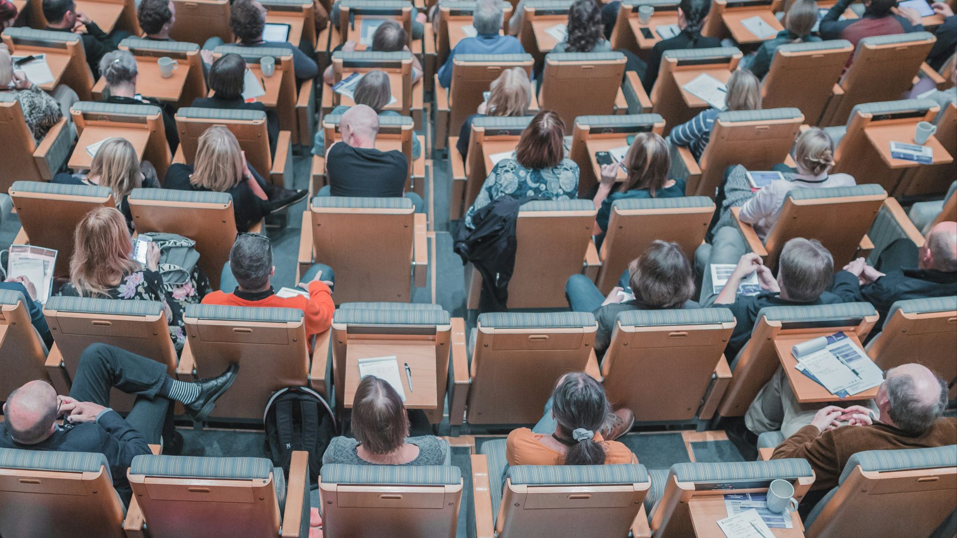 high-angle photography of group of people sitting at chairs