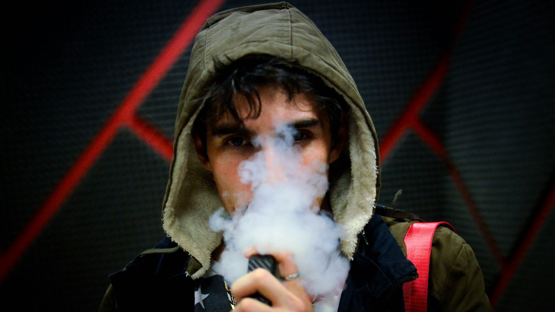 man in hoodie vaping