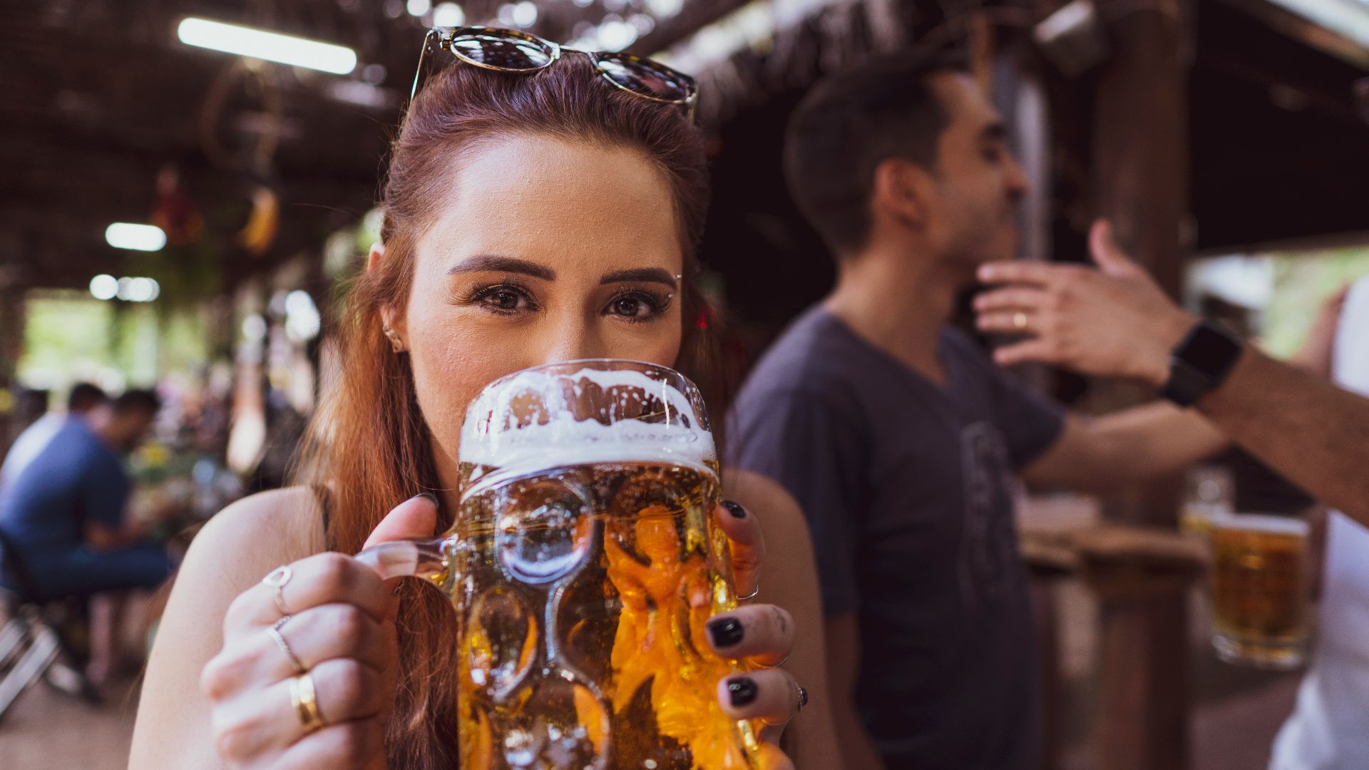 woman in black long sleeve shirt holding drinking glass