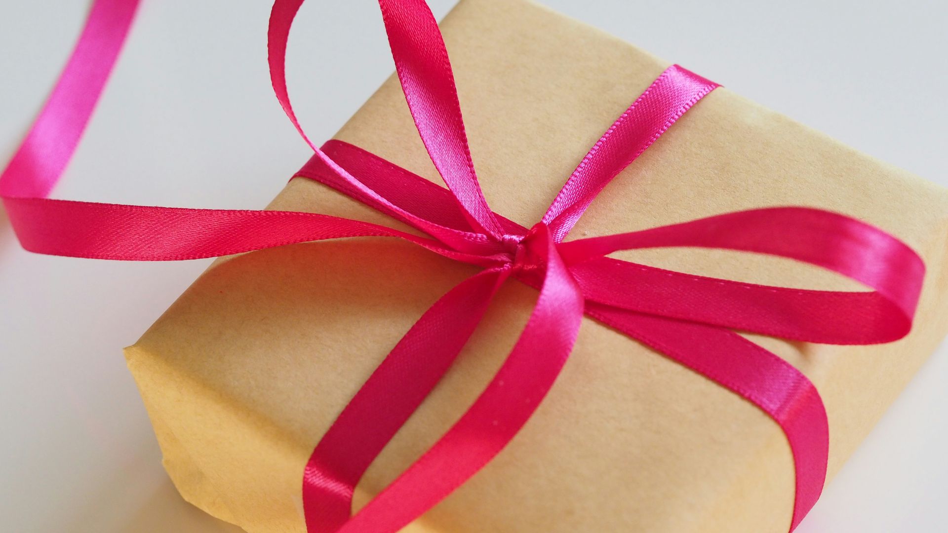 brown gift box with pink ribbon