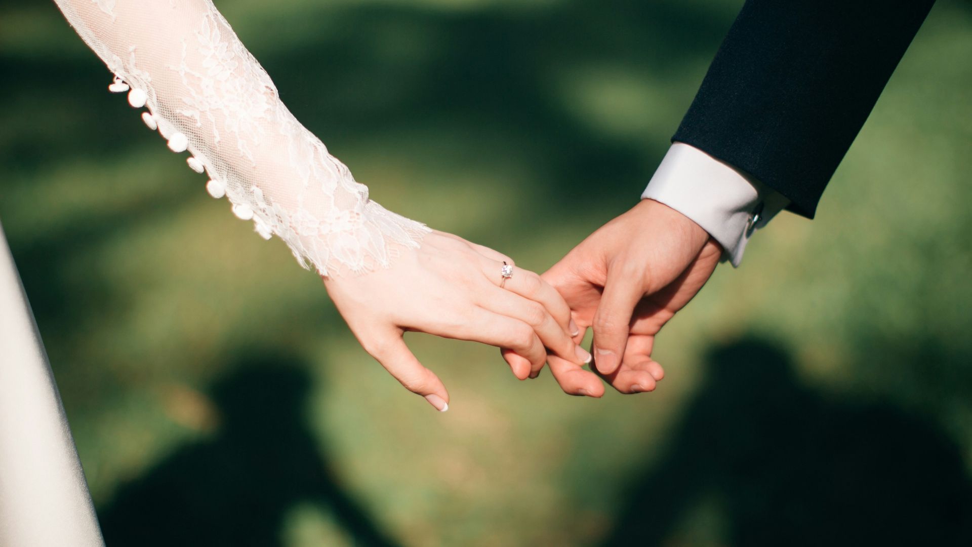man and woman holding hands focus photo