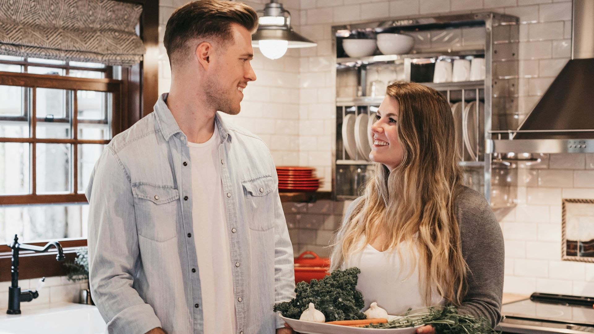 man and woman standing inside kitchen room