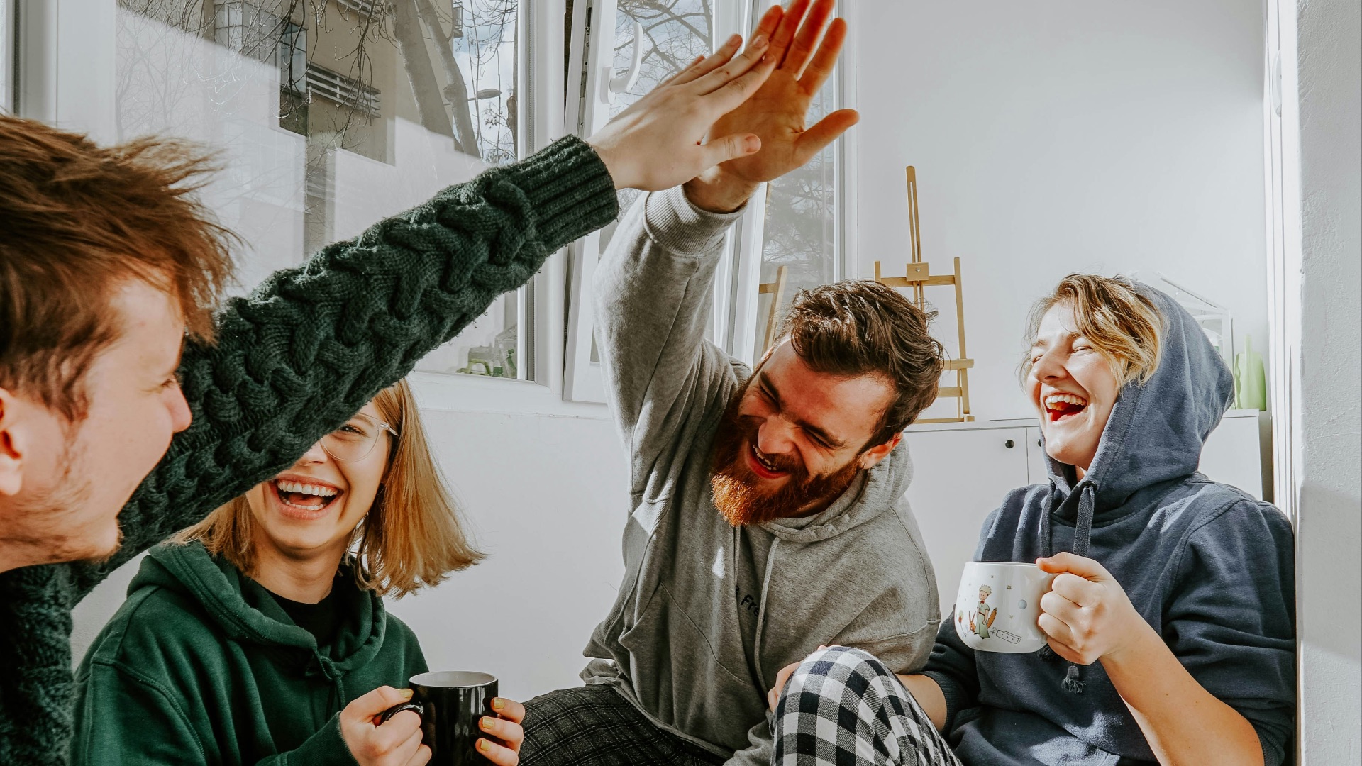 woman in black and white checkered long sleeve shirt sitting beside man in green crew neck