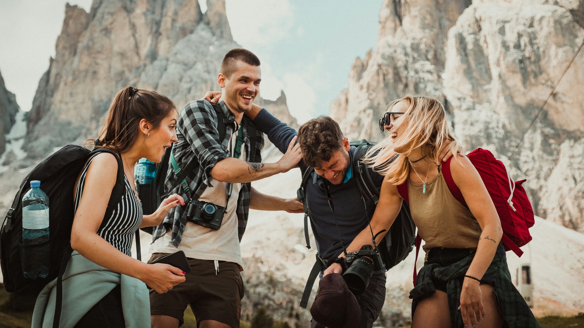low-angle photography of two men playing beside two women