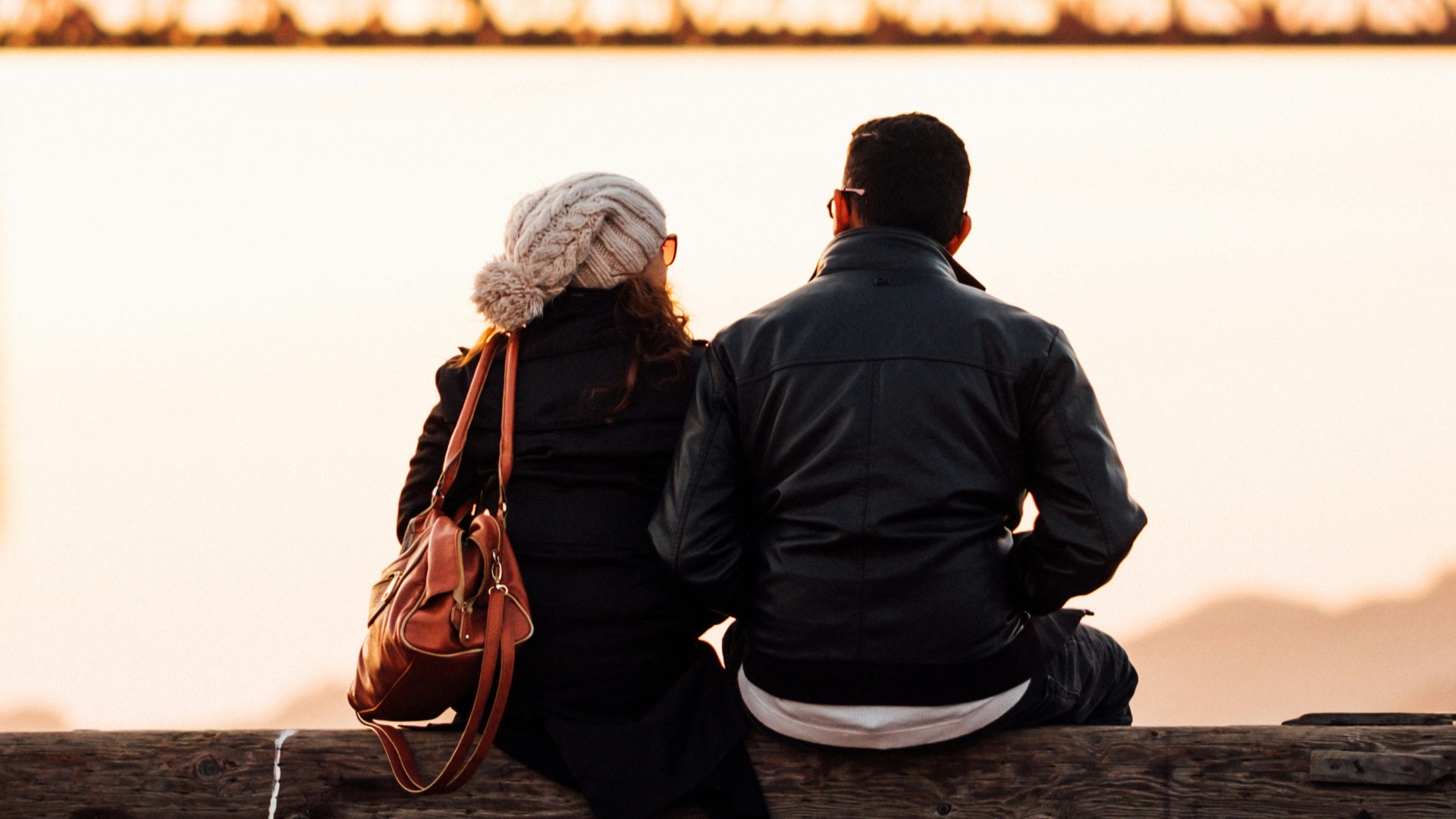 man sitting beside woman also sitting outside