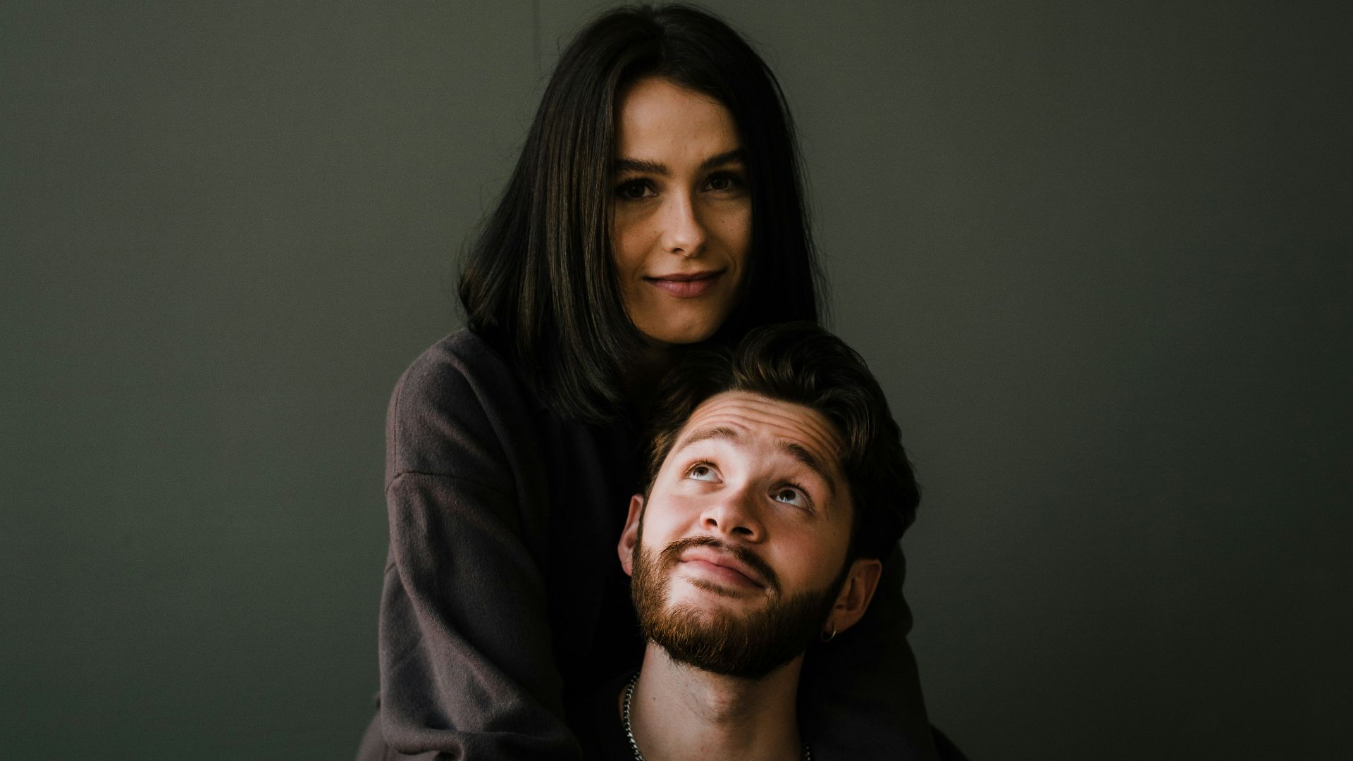 man in black crew neck shirt beside woman in black long sleeve shirt