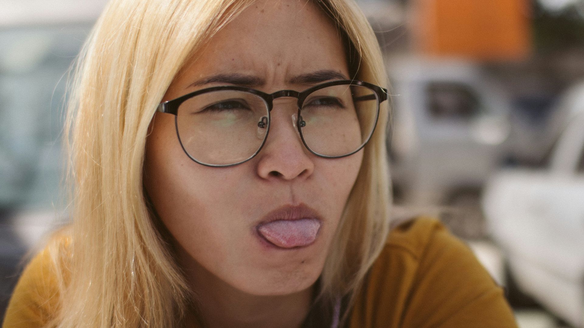 a woman with glasses making a funny face