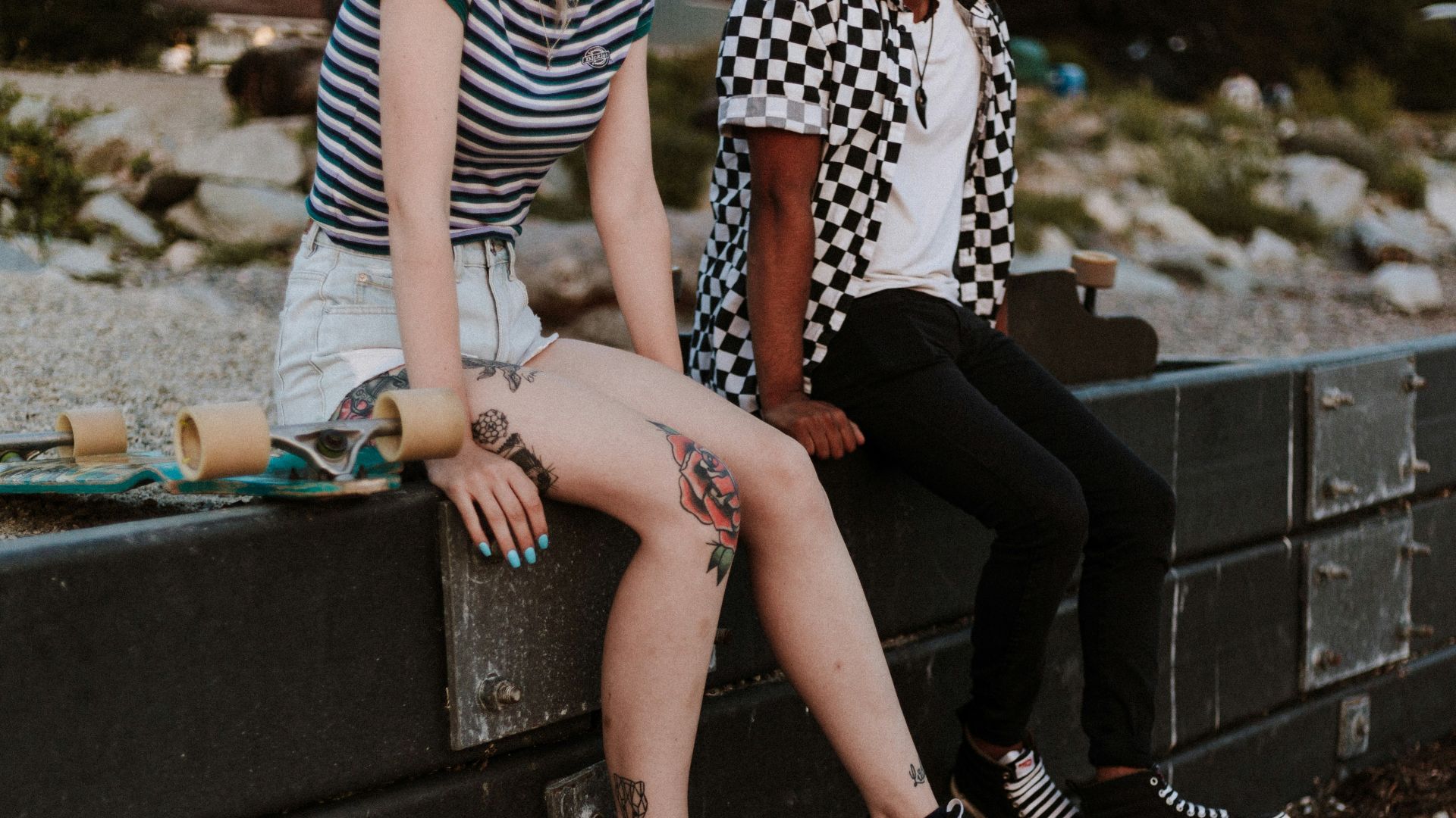 two person sits on fence