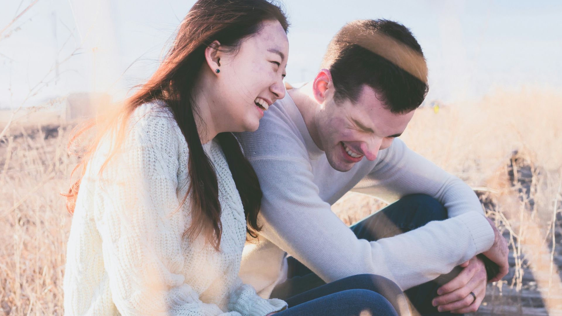 photo of man and woman laughing during daytime