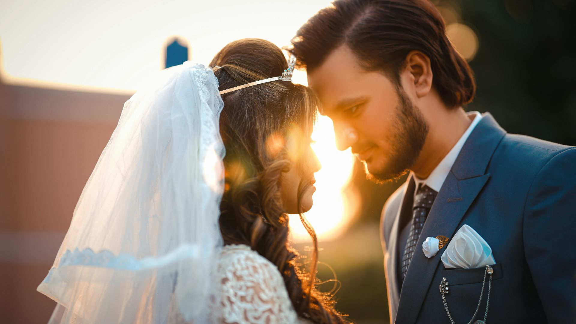 A bride and groom standing next to each other