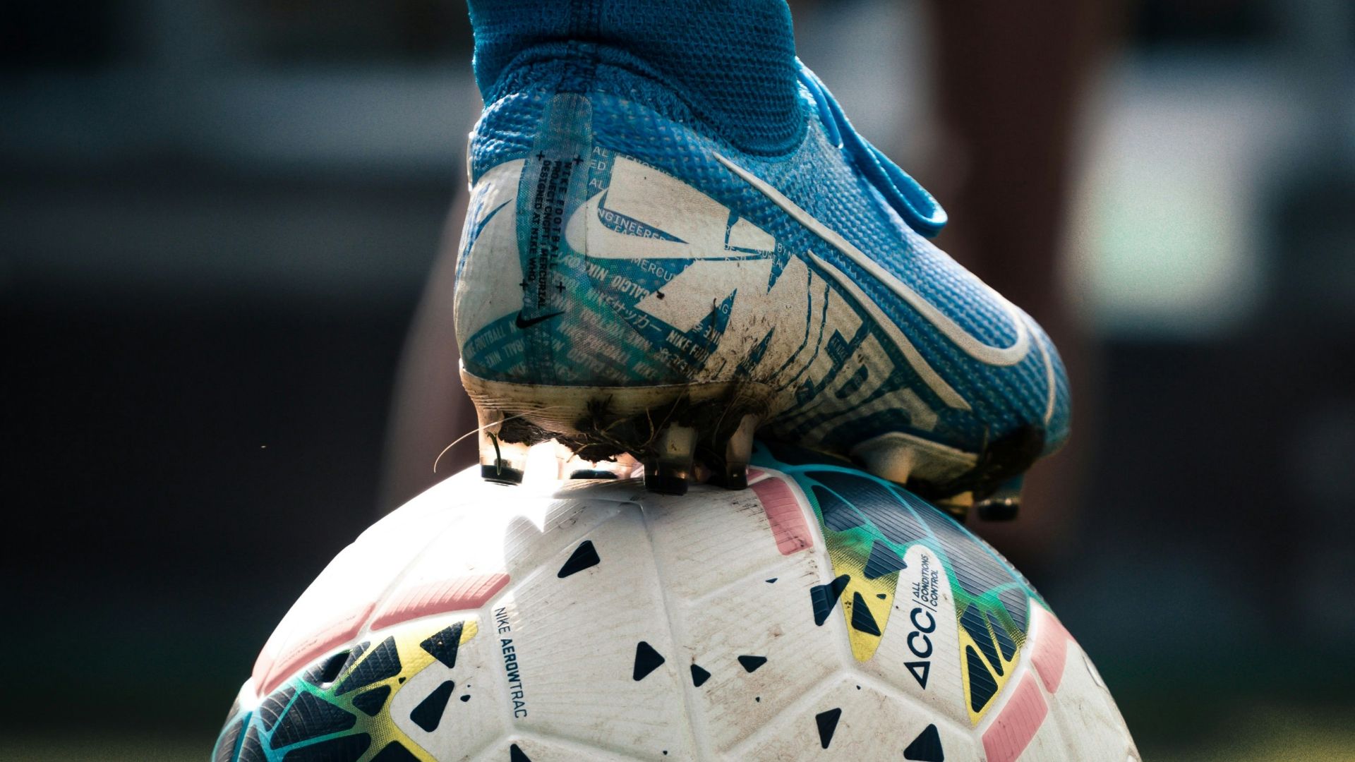white and blue soccer ball on green grass field