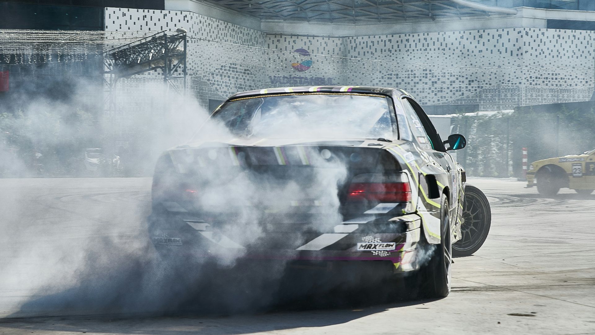 black car drifting during daytime