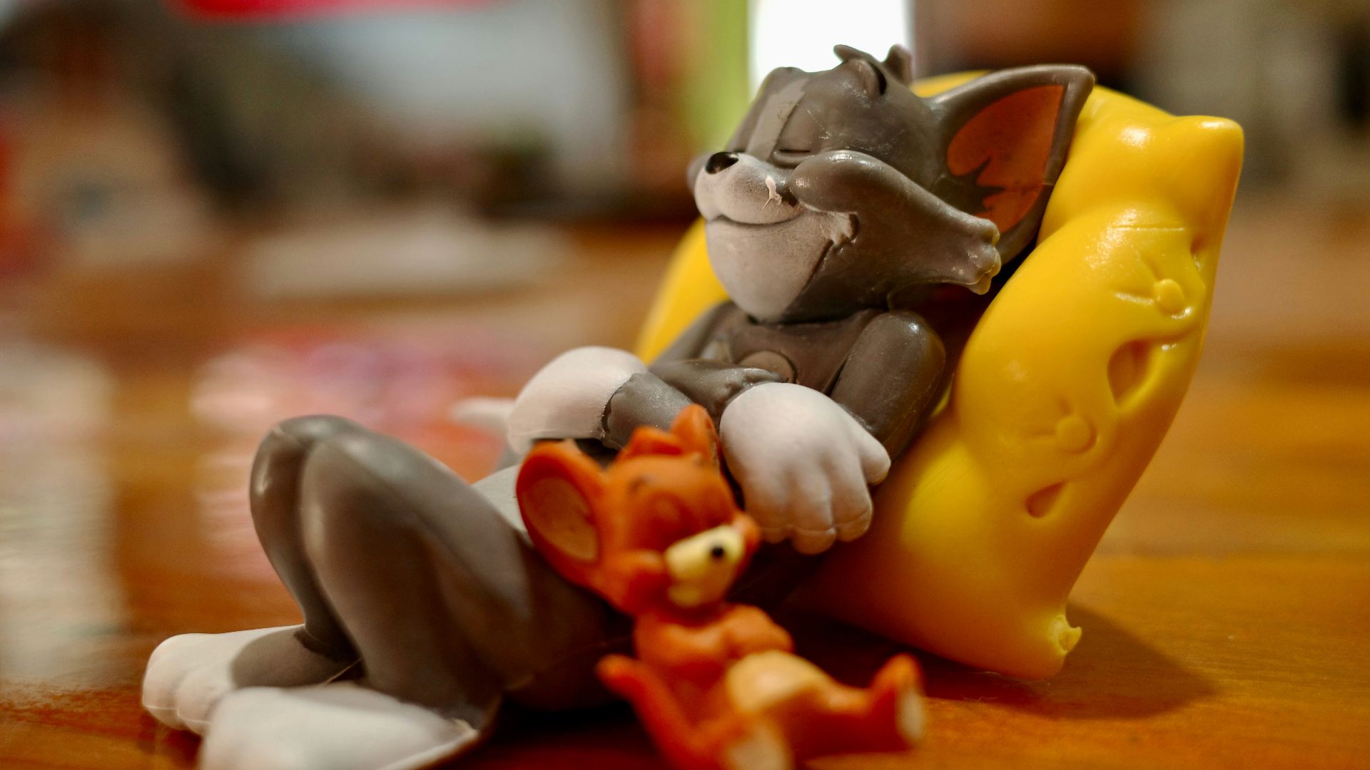 A cat figurine sitting on top of a wooden table