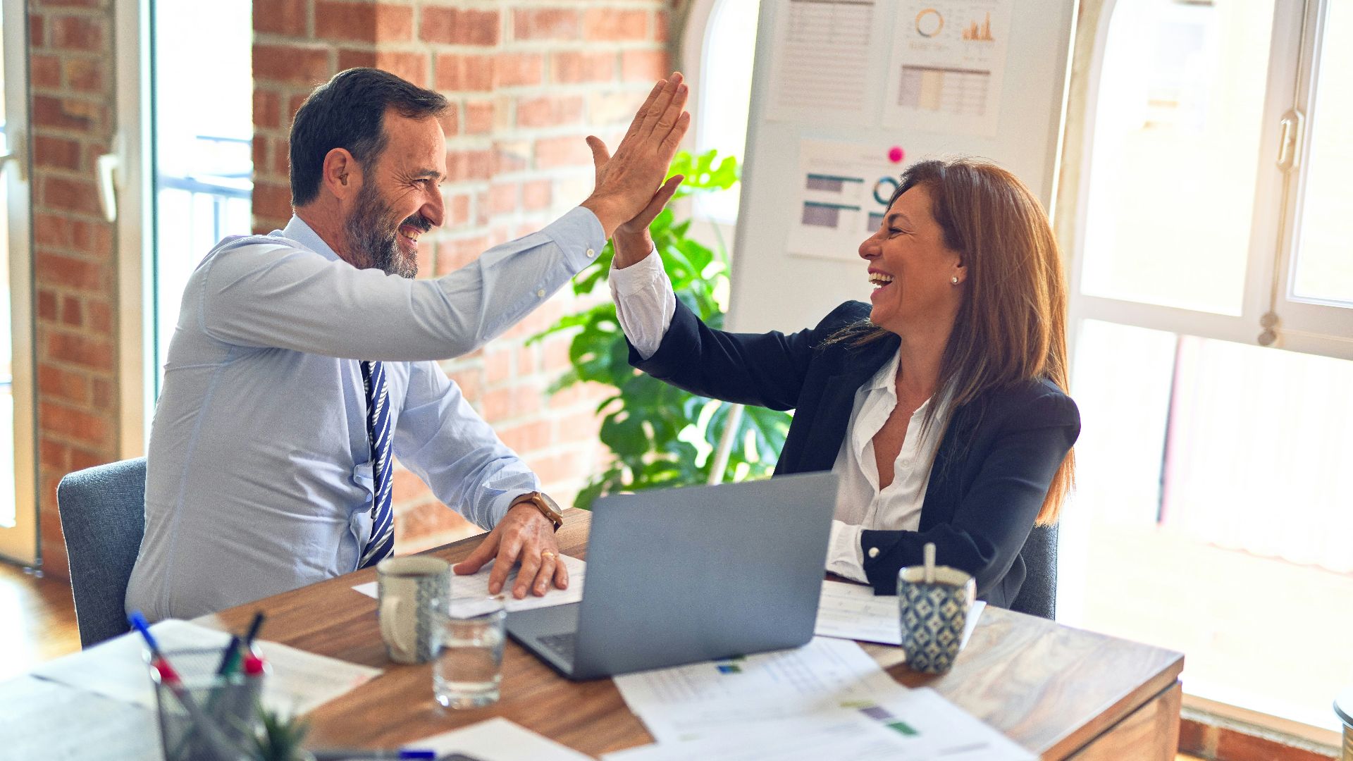 man in white dress shirt sitting beside woman in black long sleeve shirt