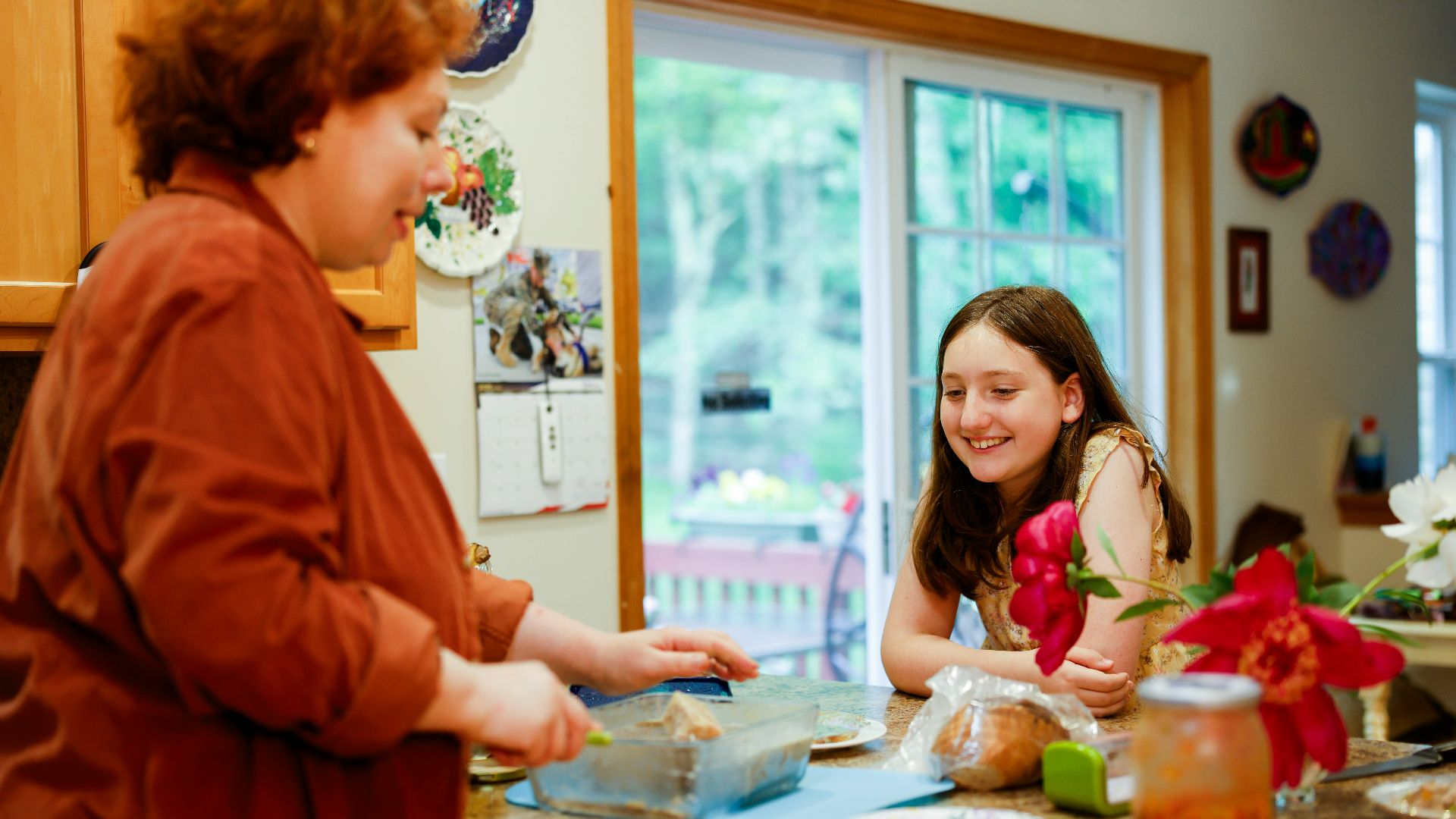 Woman preparing food with a girl watching