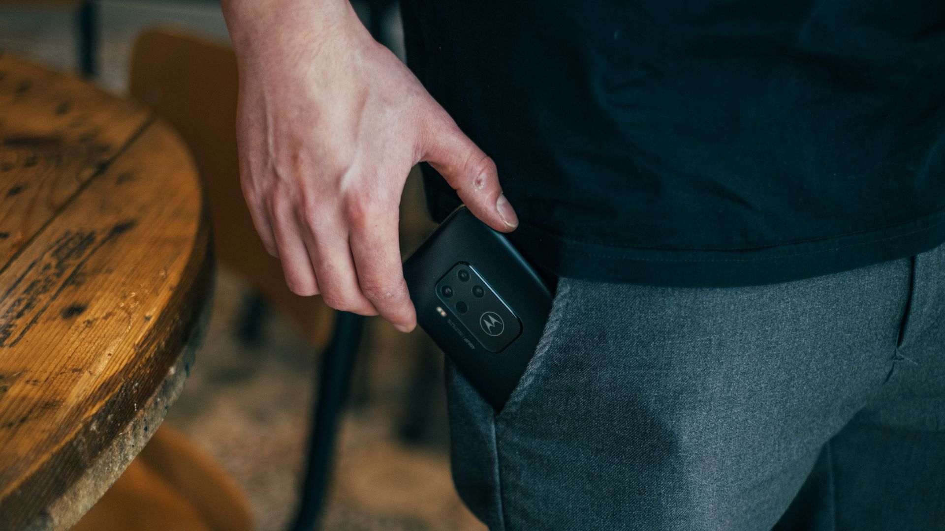 person inserting smartphone in pocket