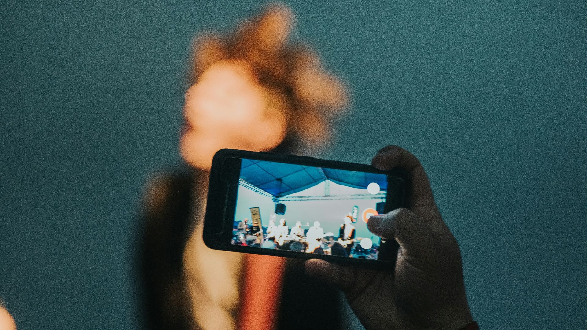 person holding black smartphone taking photo of brown mountain during daytime