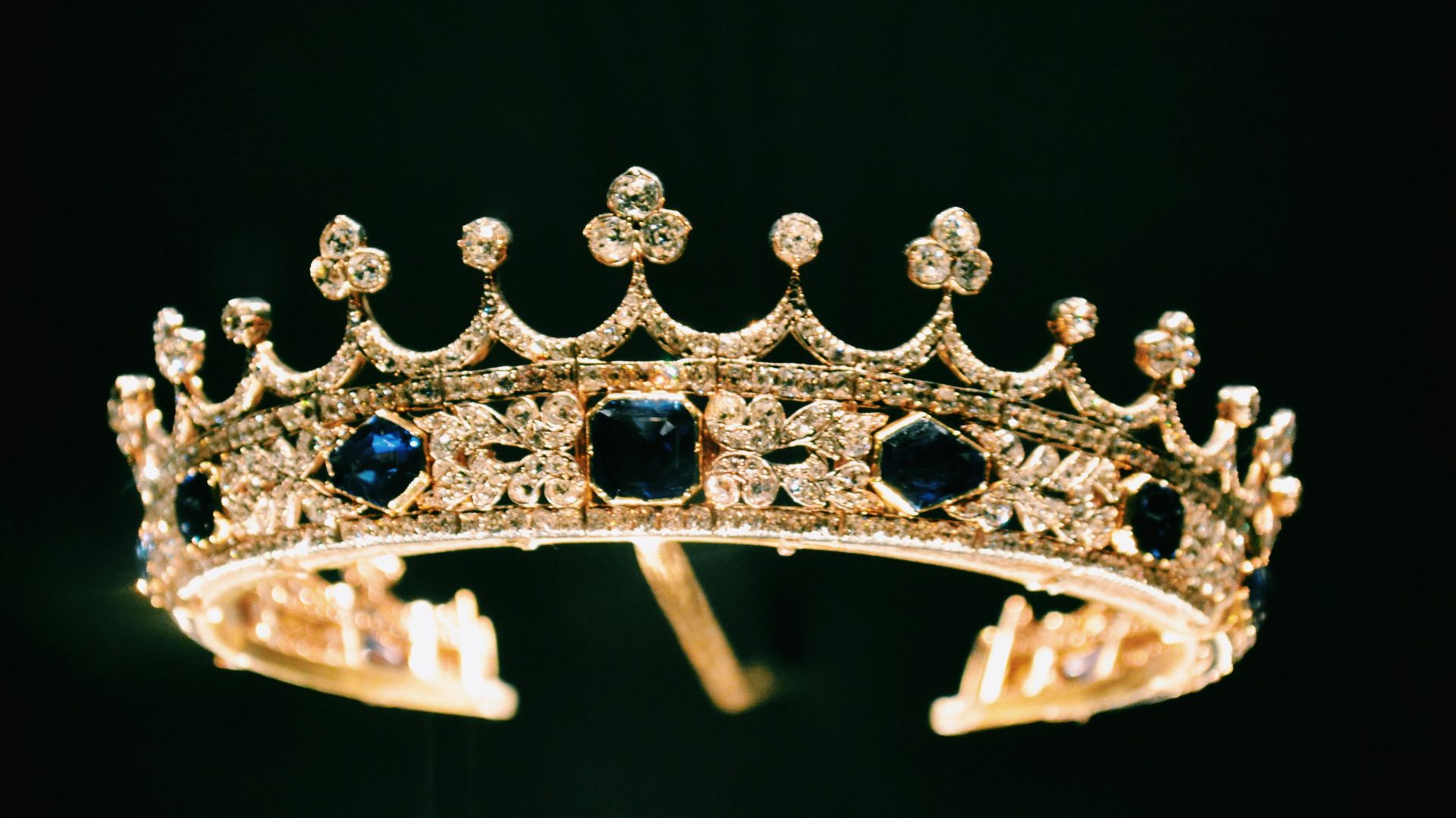 silver diamond studded crown with black background