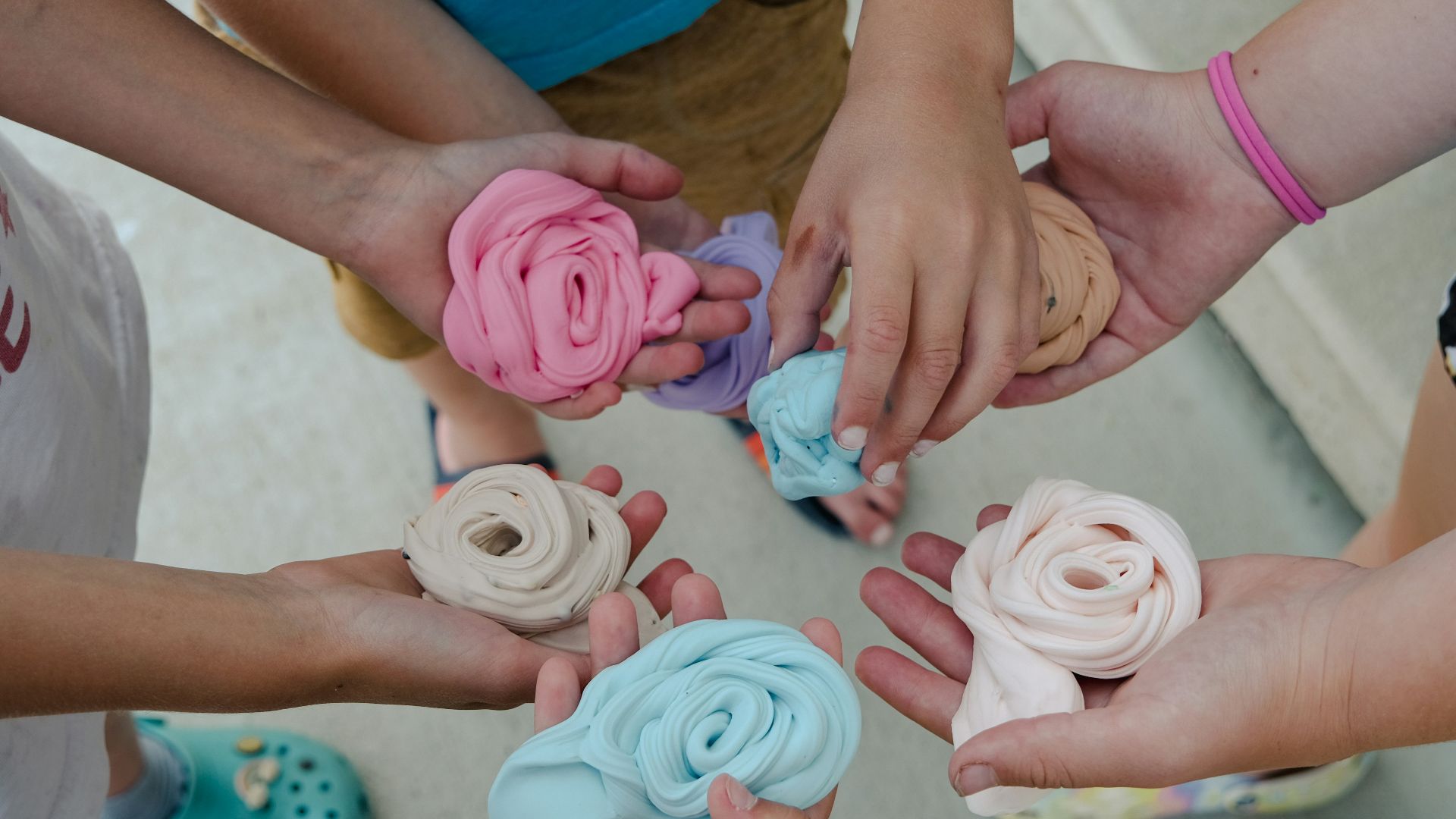 a group of children holding small doughnuts in their hands