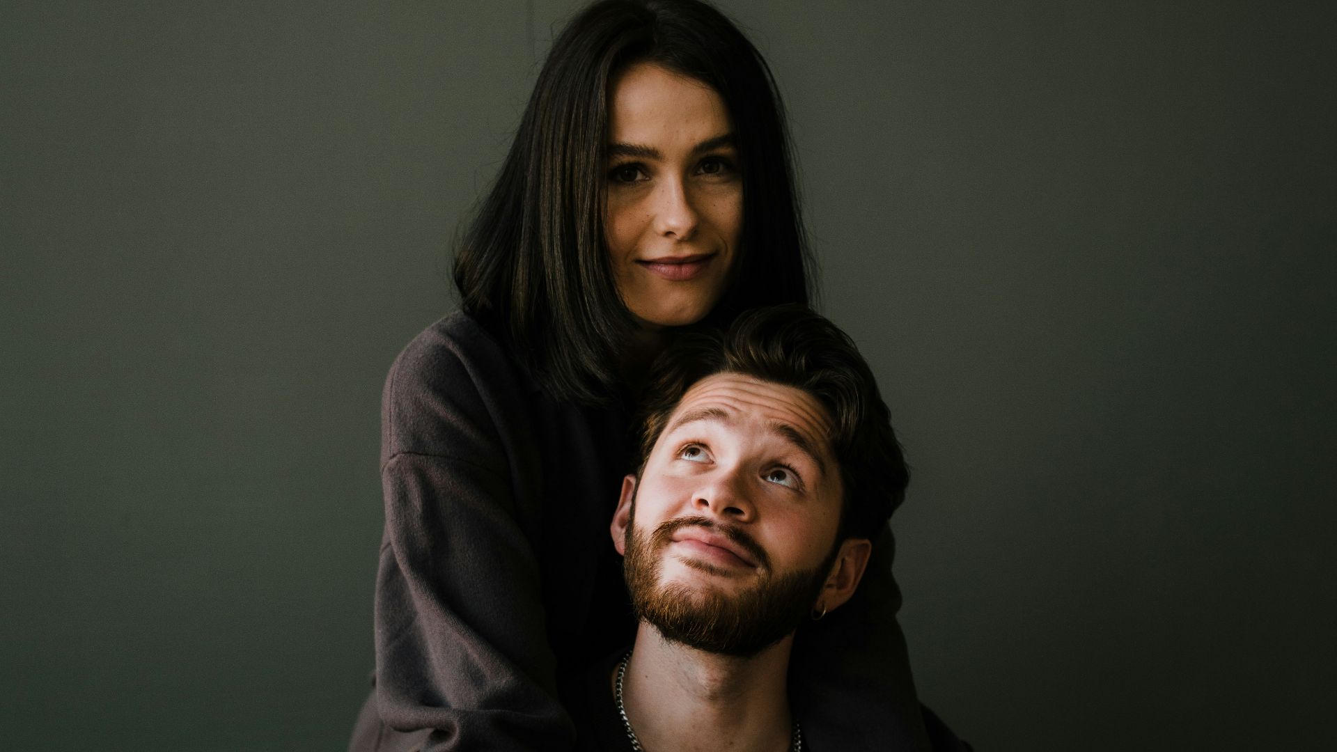 man in black crew neck shirt beside woman in black long sleeve shirt