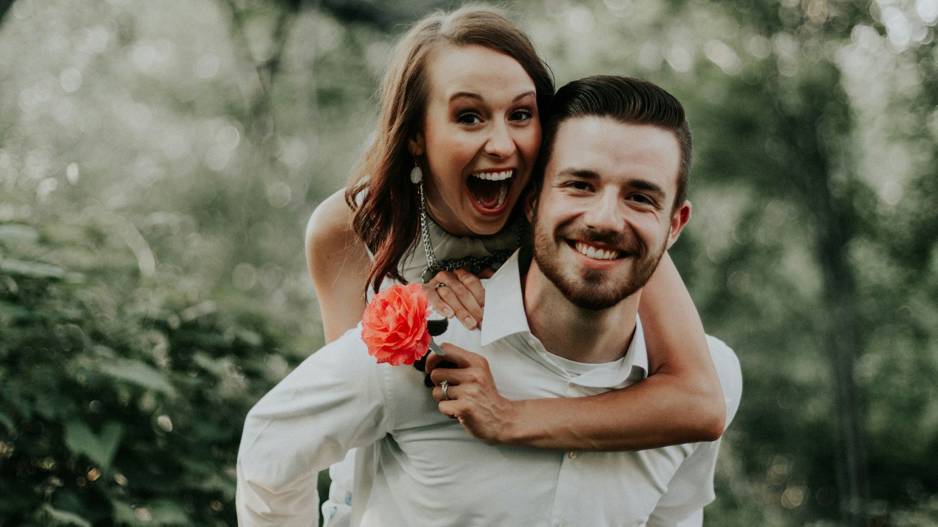 woman riding on back of man