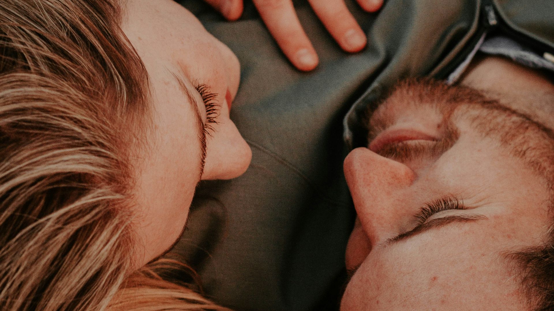 a woman stares into a man's eyes lovingly
