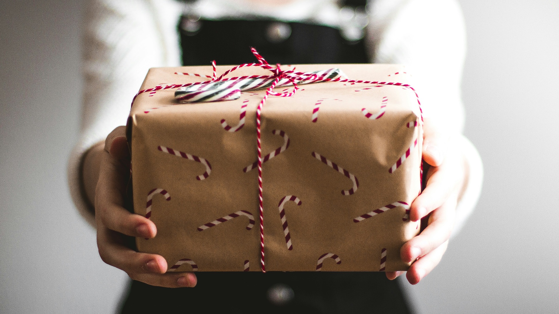 person showing brown gift box