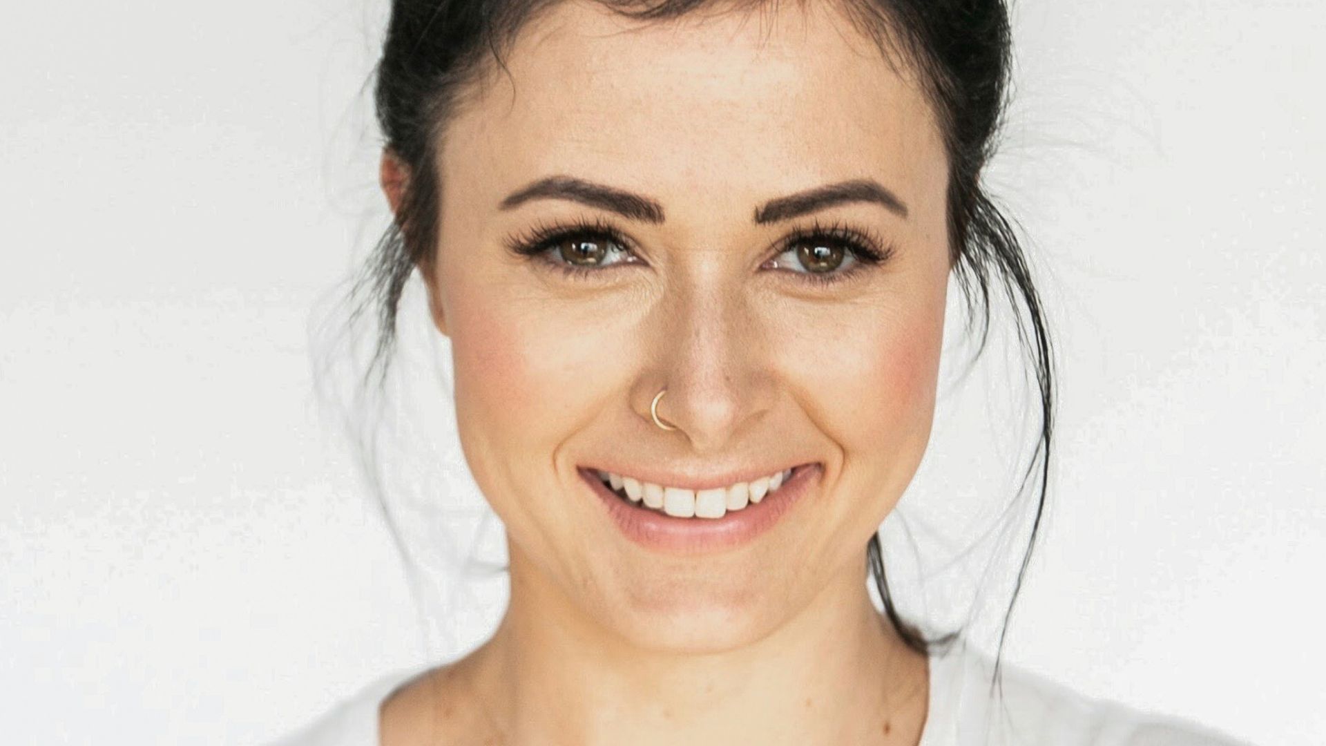woman in white crew neck shirt smiling