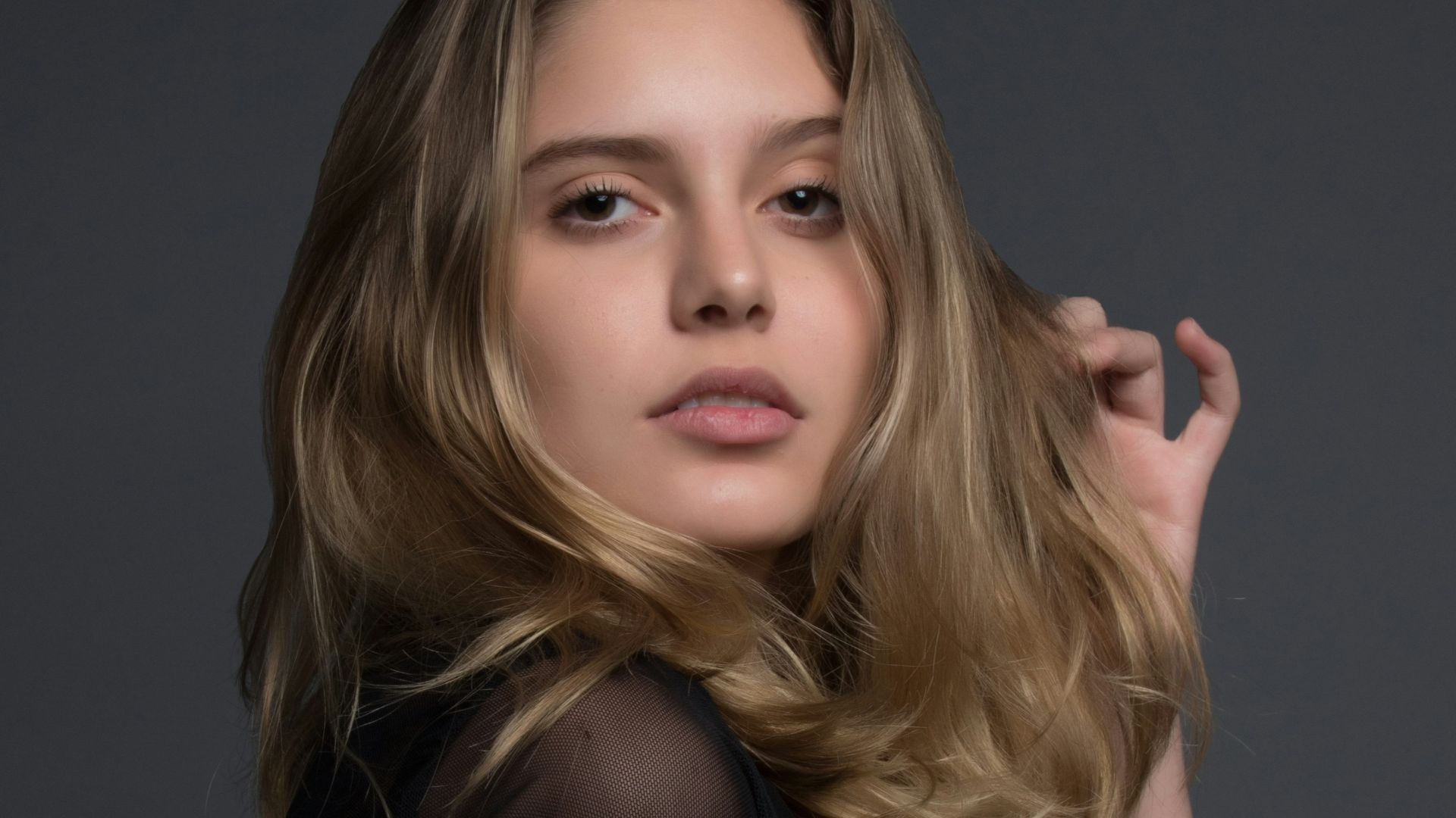 woman holding heft long blonde hair