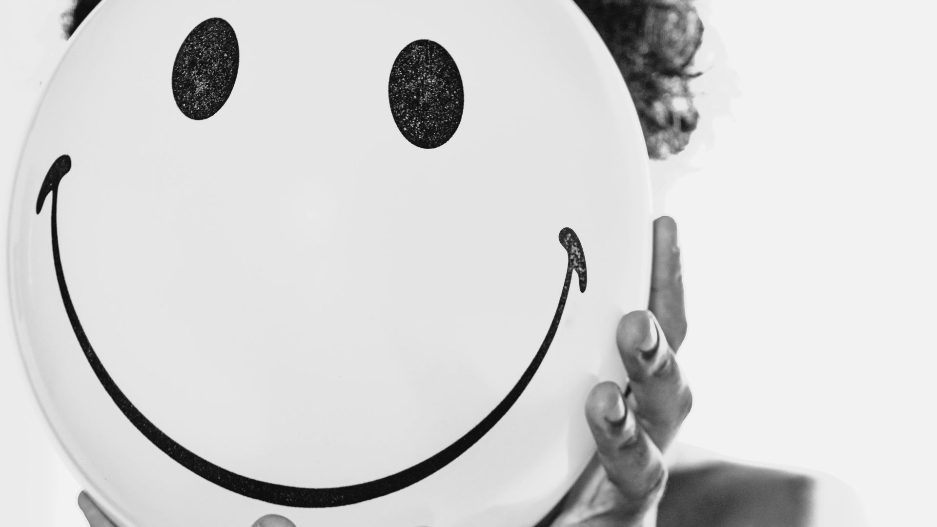 person holding white round ornament