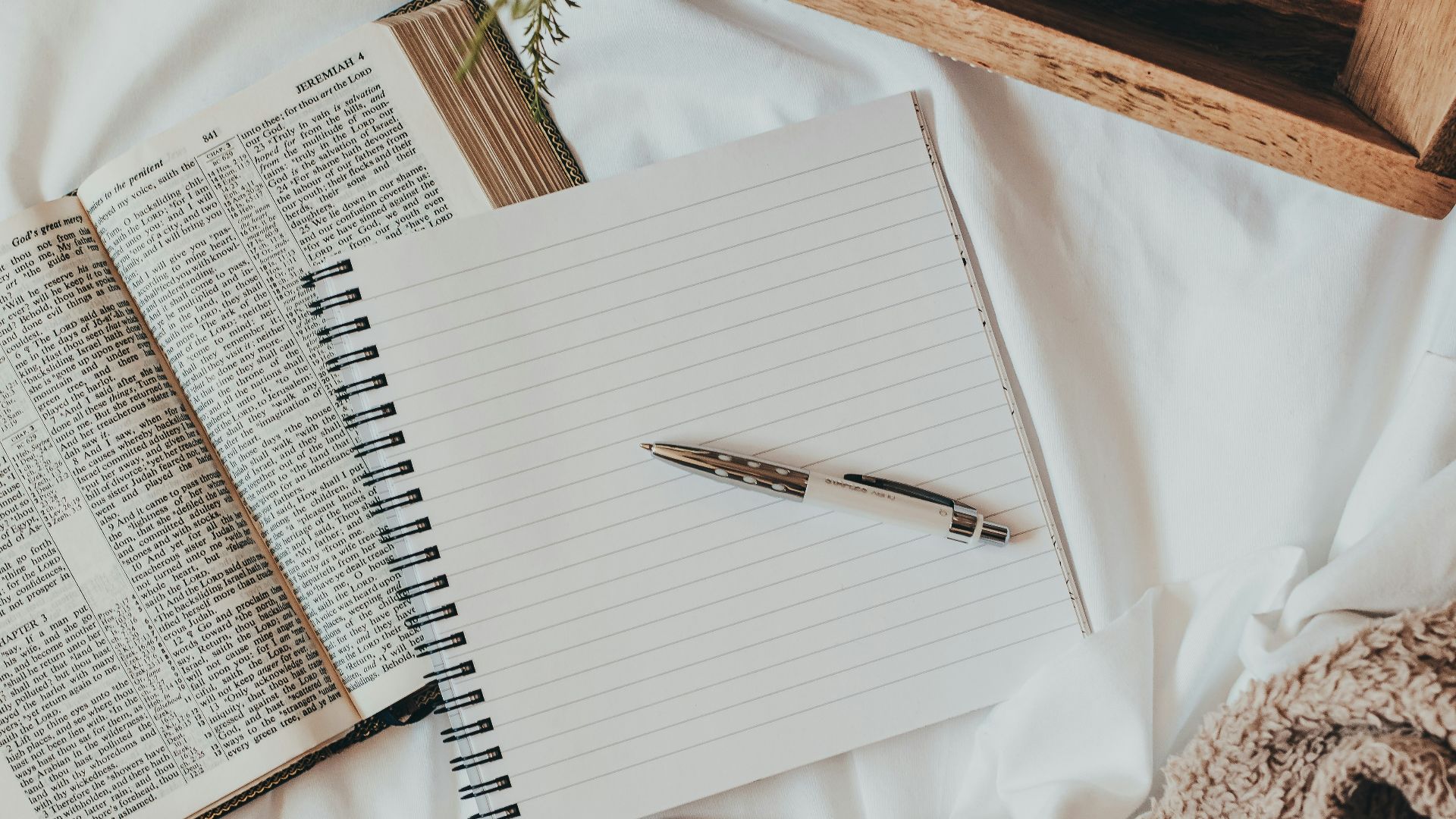 white notebook on white textile