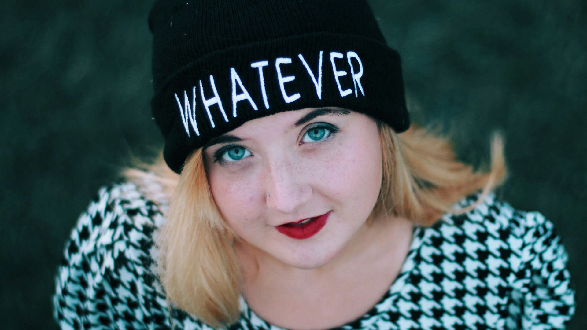 smiling woman wearing black knit cap