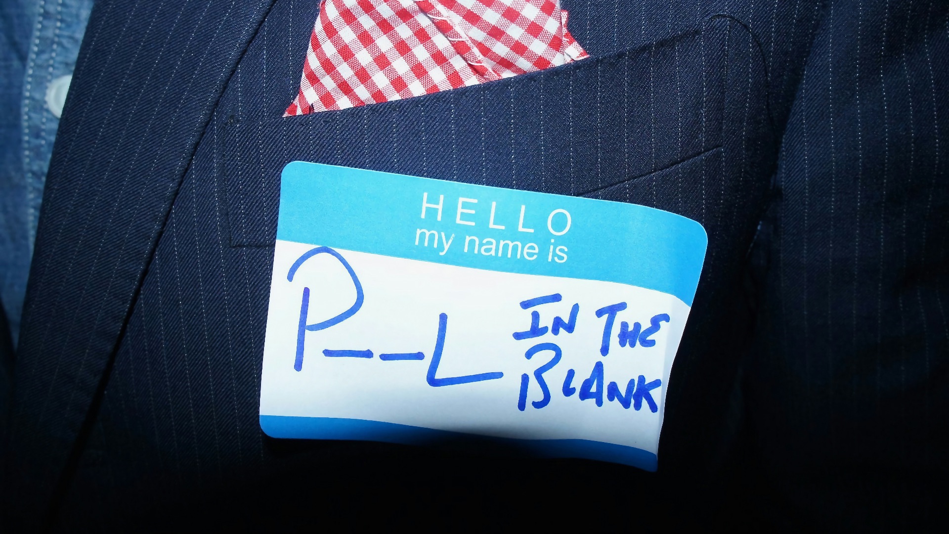 a close up of a person wearing a suit and tie