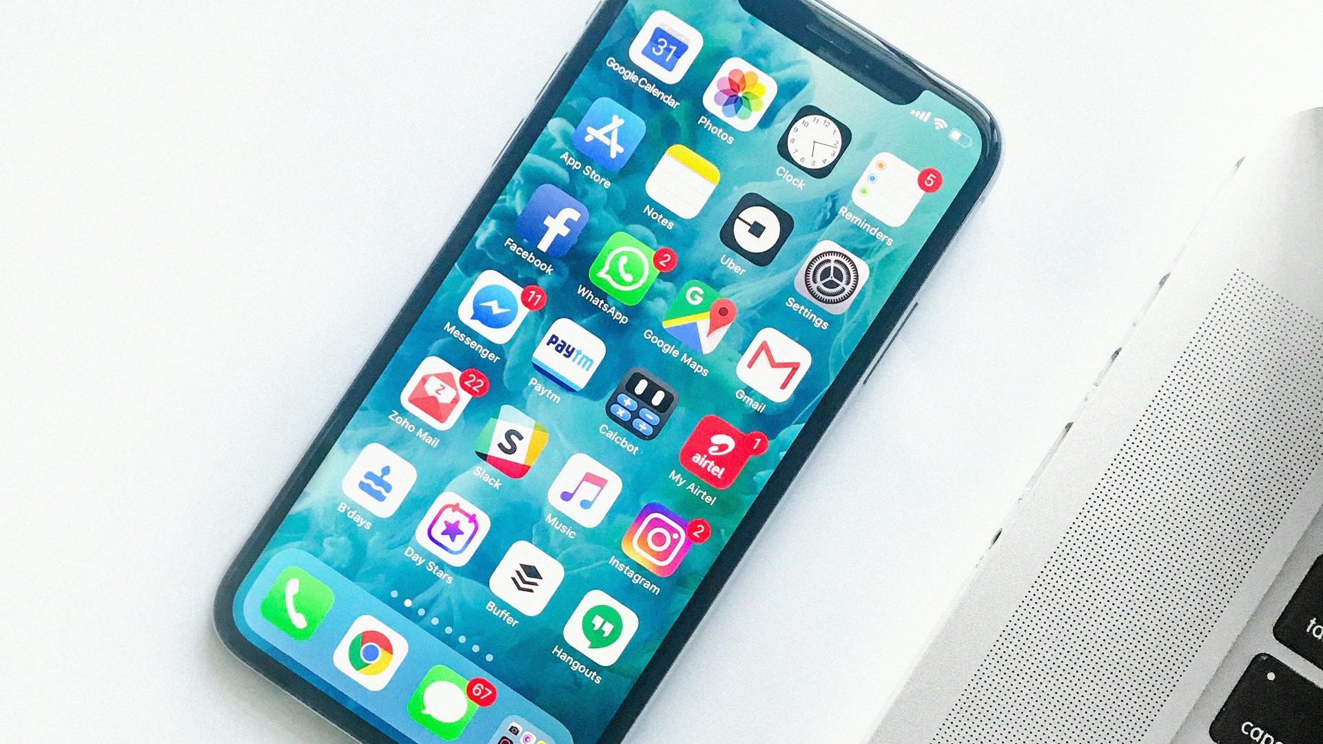 white smartphone near laptop