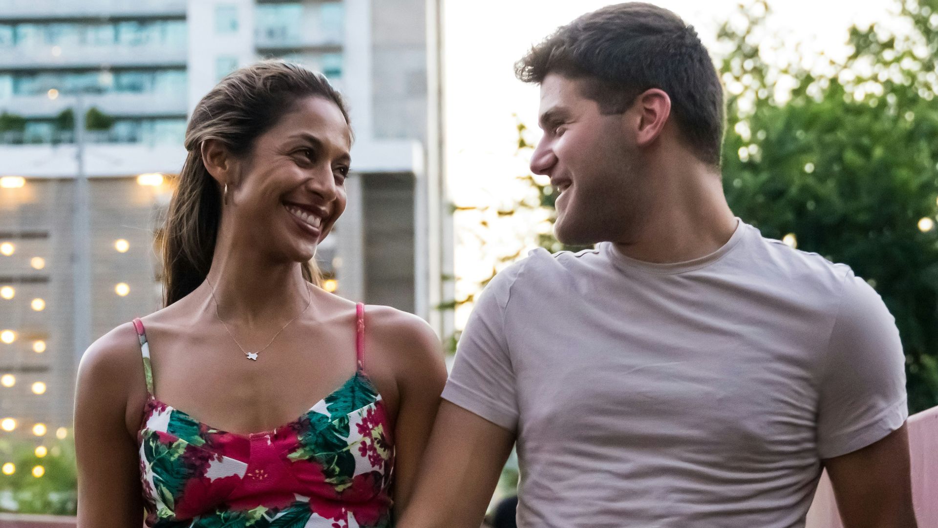 man and woman standing on wooden bridge during daytime